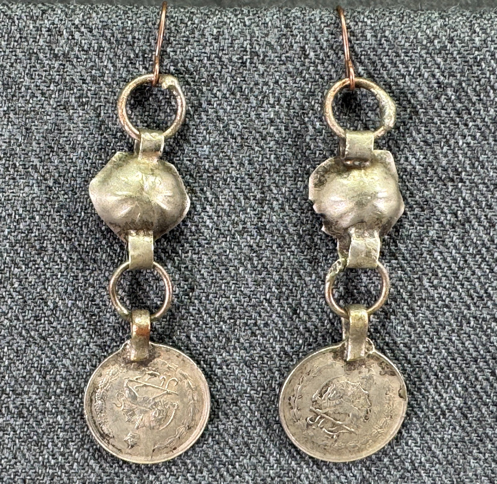 Vintage tribal Persian coin dangles silver earrings: Vintage tribal Persian coin dangles silver earrings. Golden hooks. Unmarked. For measures please refer to the pictures taken with a measuring tape. Weight: 7 Grams. IN HOUSE Estimated* shipping and ha