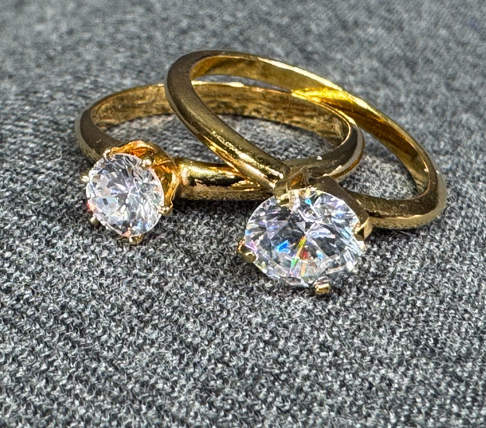 Small & big CZ goldtone metal solitaire rings . Both size 8: Small & big CZ goldtone metal solitaire rings. Both size 8. Unmarked. Size is around 8 (please see pic taken with sizer). For measures please refer to the pictures taken with a measuring tape. Weight: