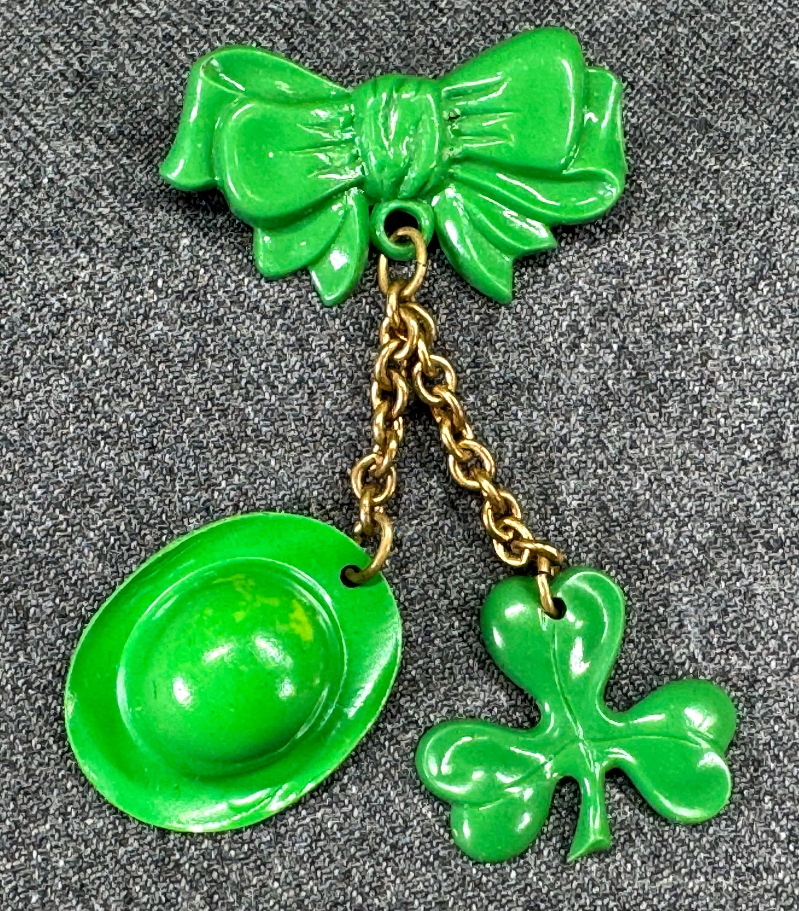 Vintage St. Patrick's Day Green Celluloid Shamrock & Leprechaun Hat Dangling from Bow Pin Brooch: IN HOUSE FLAT SHIPPING & HANDLING COST WITHIN ALL THE U.S. : $7 To bypass LiveShipping, and use our In-House shipping service for $7 or shipping combined for multiple lots, please select “Arrange Yo