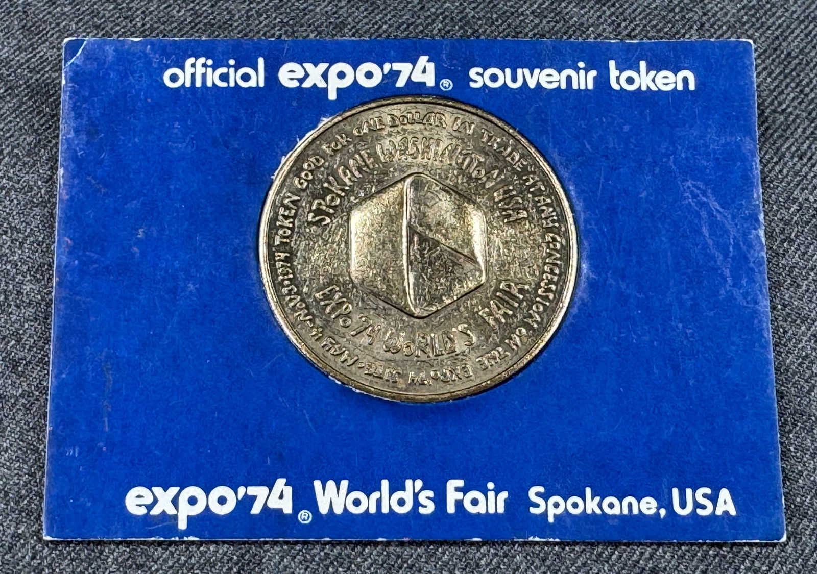 1 Dollar token Spokane EXPO'74 in cardboard: IN HOUSE FLAT SHIPPING & HANDLING COST WITHIN ALL THE U.S. : $7 To bypass LiveShipping, and use our In-House shipping service for $7 or shipping combined for multiple lots, please select “Arrange Yo