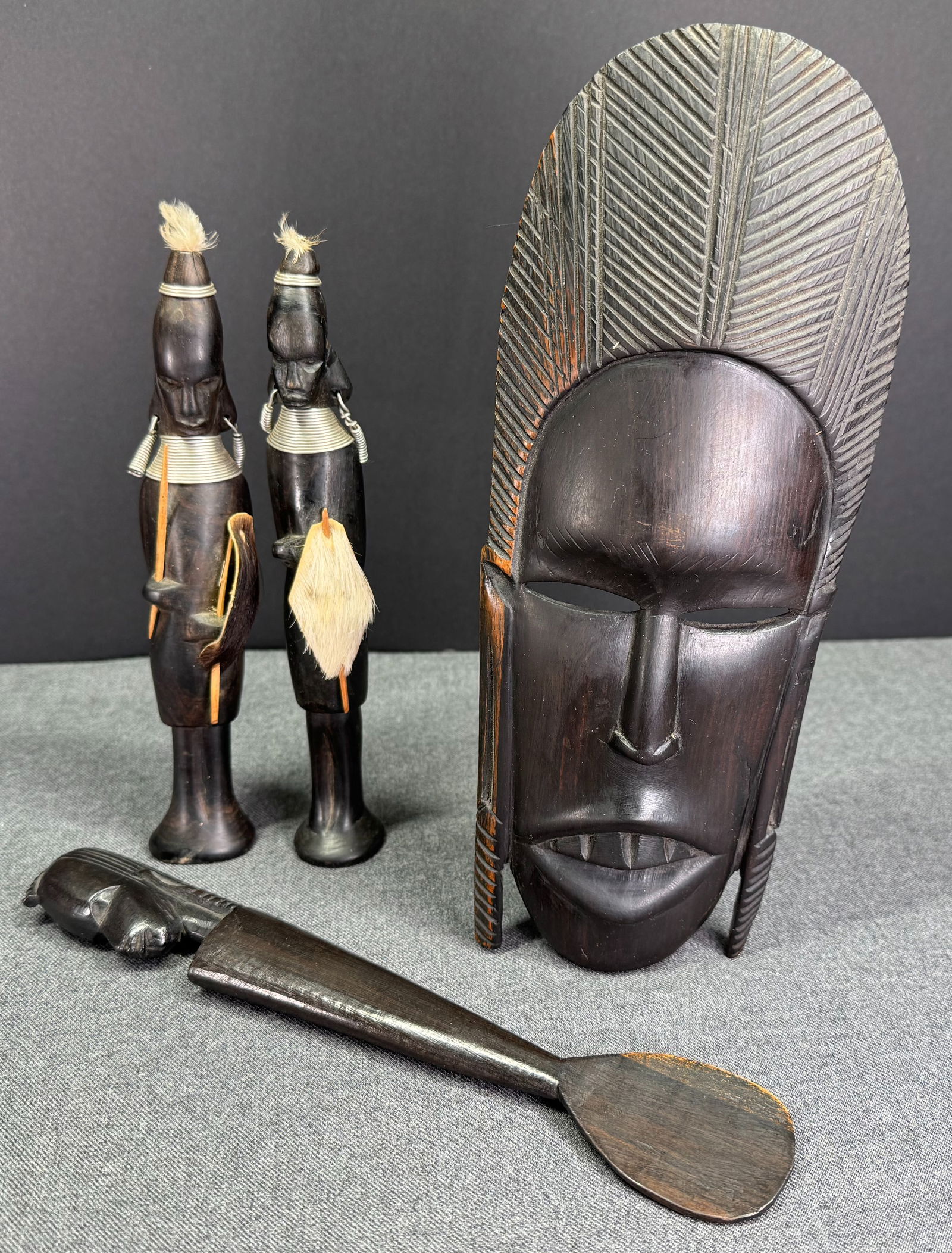Group of African Items: two figures, one mask and one spoon. Carved wood, metal fur, feathers, ebony (1 of 10)