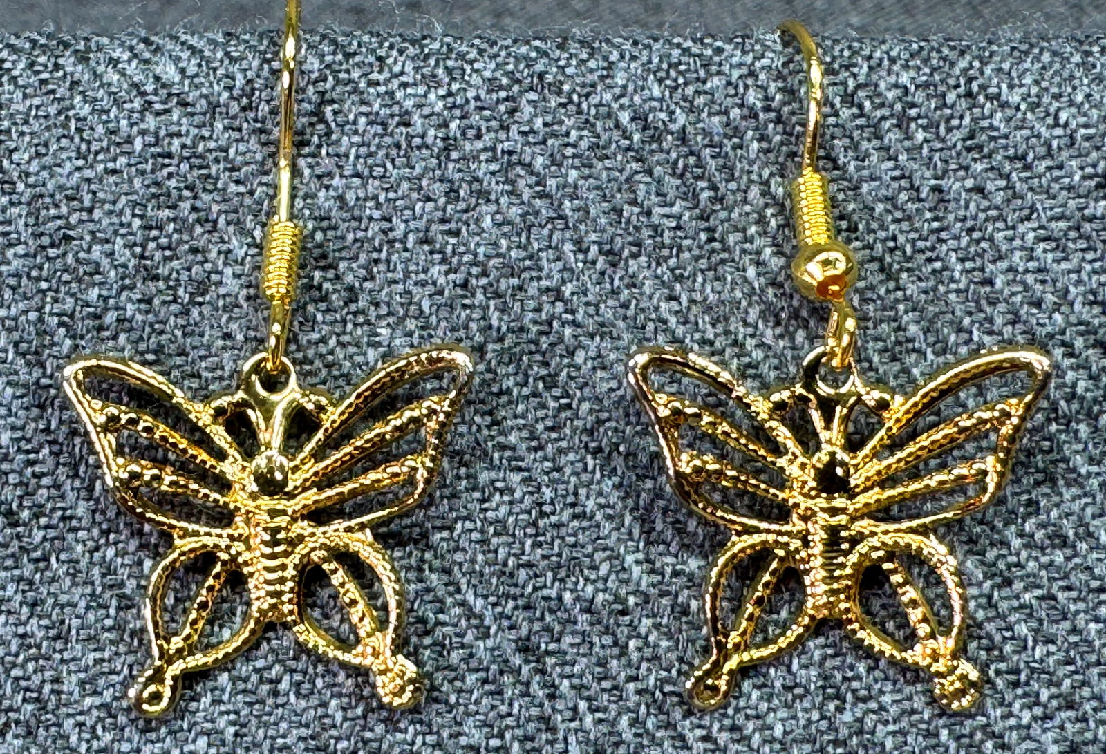 Vintage filigree gold-toned butterfly hook earrings: Vintage filigree gold-toned butterfly hook earrings. Unmarked. For measures please refer to the pictures taken with a measuring tape. Weight: 3 Grams. IN HOUSE FLAT SHIPPING & HANDLING COST WITHIN ALL