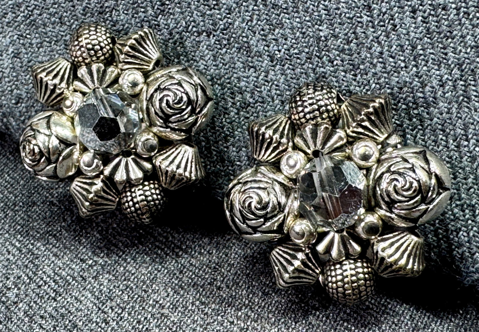 Vintage silver-toned & AB crystals cluster flower clip earrings: Vintage silver-toned & AB crystals cluster flower clip earrings. Unmarked. For measures please refer to the pictures taken with a measuring tape. Weight: 11 Grams. IN HOUSE FLAT SHIPPING & HANDLING CO