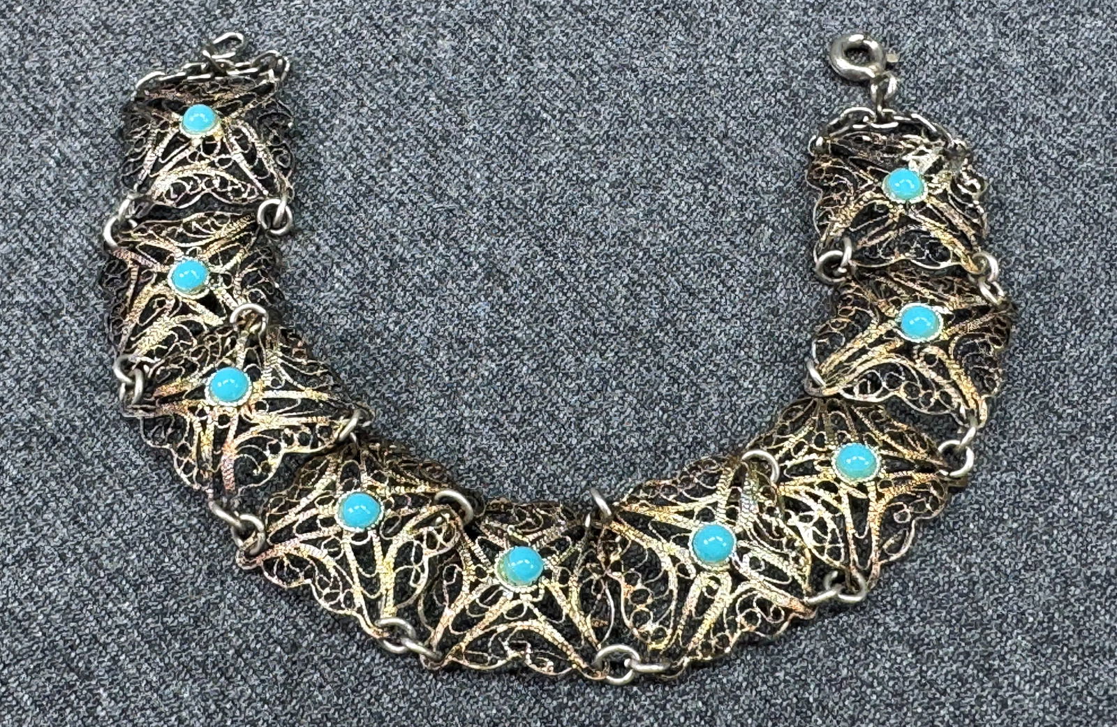 Vintage turquoise color beads filigree silver-toned panels bracelet. *B: Vintage turquoise color plastic beads filigree silver-toned panels bracelet. Unmarked. For measures please refer to the pictures taken with a measuring tape. Weight: 7 Grams. IN HOUSE FLAT SHIPPING &