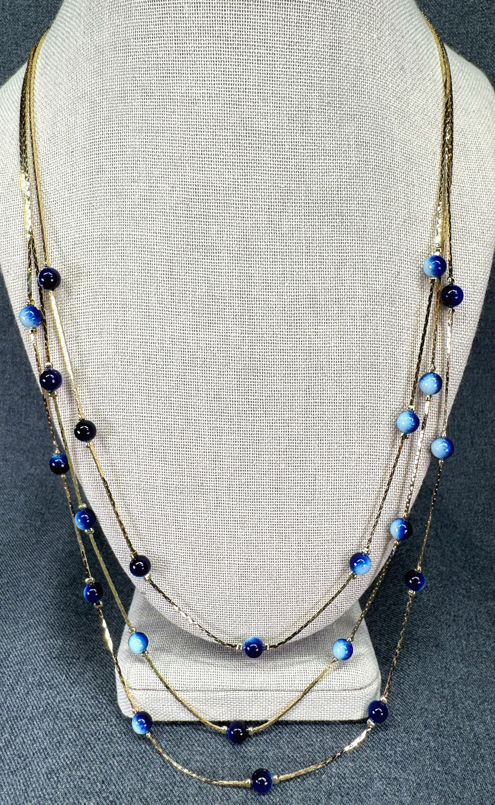 Vintage bluish resin beads gold-toned snake chain 3 strands necklace. #a: Vintage bluish resin beads gold-toned snake chain 3 strands necklace. Unmarked. For measures please refer to the pictures taken with a measuring tape. Weight: 14 Grams. IN HOUSE FLAT SHIPPING & HANDLI