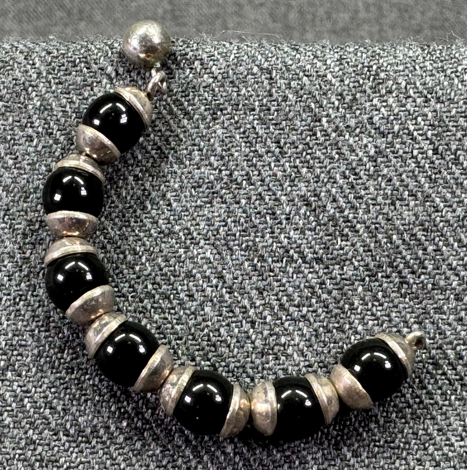 Vintage black glass beads silver-toned hoop single stud earring. #B: Vintage black glass beads silver-toned hoop single stud earring. Unmarked. For measures please refer to the pictures taken with a measuring tape. Weight: 4.39 Grams. IN HOUSE FLAT SHIPPING & HANDLING
