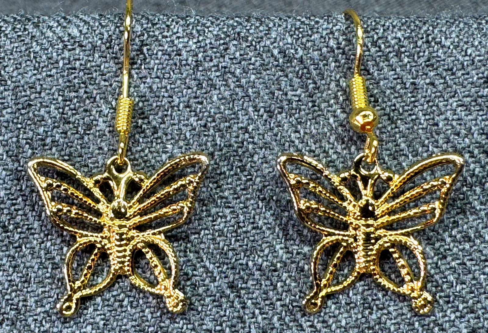 Vintage filigree gold-toned butterfly hook earrings: Vintage filigree gold-toned butterfly hook earrings. Unmarked. For measures please refer to the pictures taken with a measuring tape. Weight: 3 Grams. IN HOUSE FLAT SHIPPING & HANDLING COST WITHIN ALL