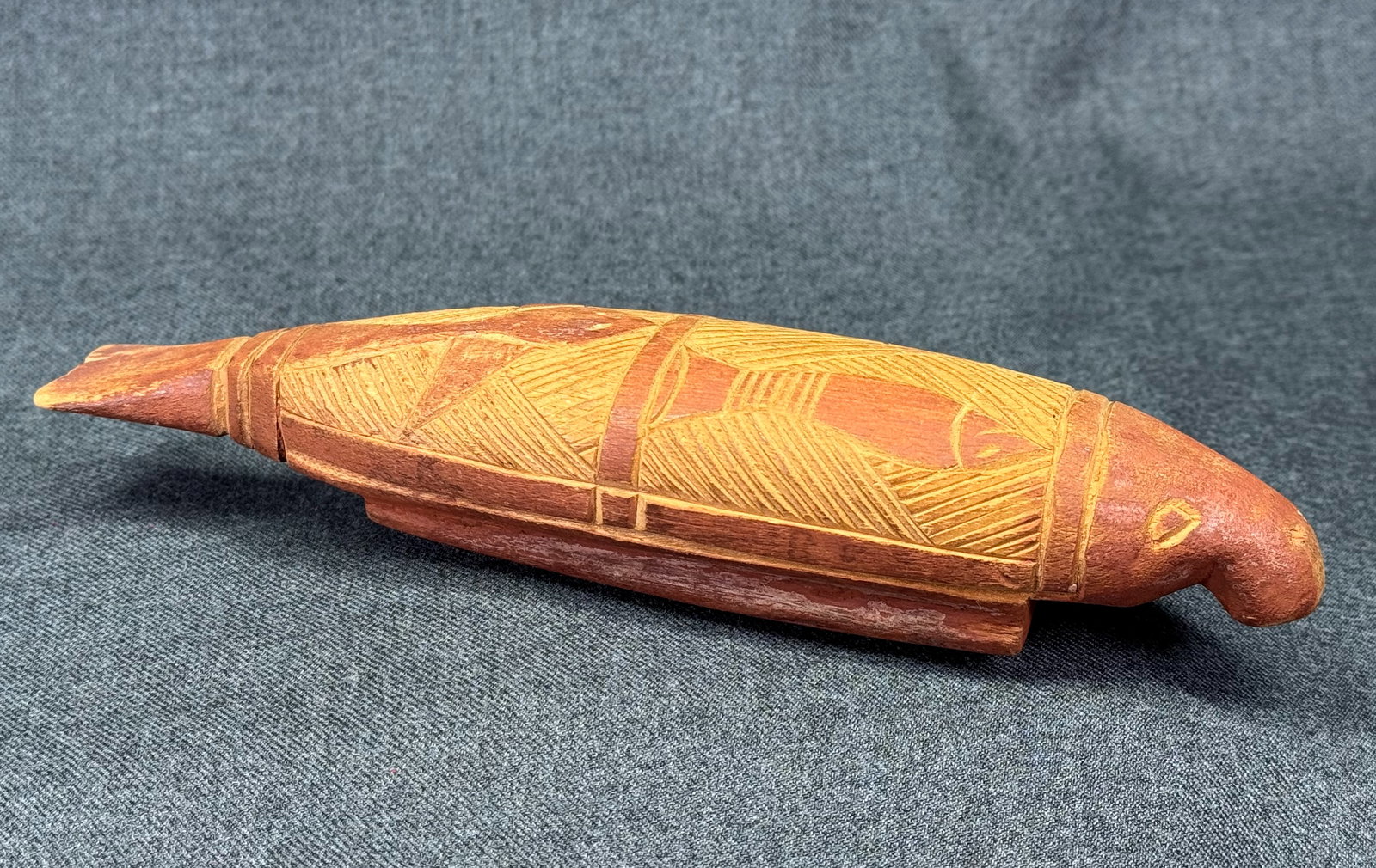Aboriginal Australia Dugong Figure. *c: Aboriginal Australia Dugong Figure.Carved and decorated wood with ochre. Paper label on the bottom. For measures please refer to the pictures taken with a measuring tape. IN HOUSE FLAT SHIPPING & HAND
