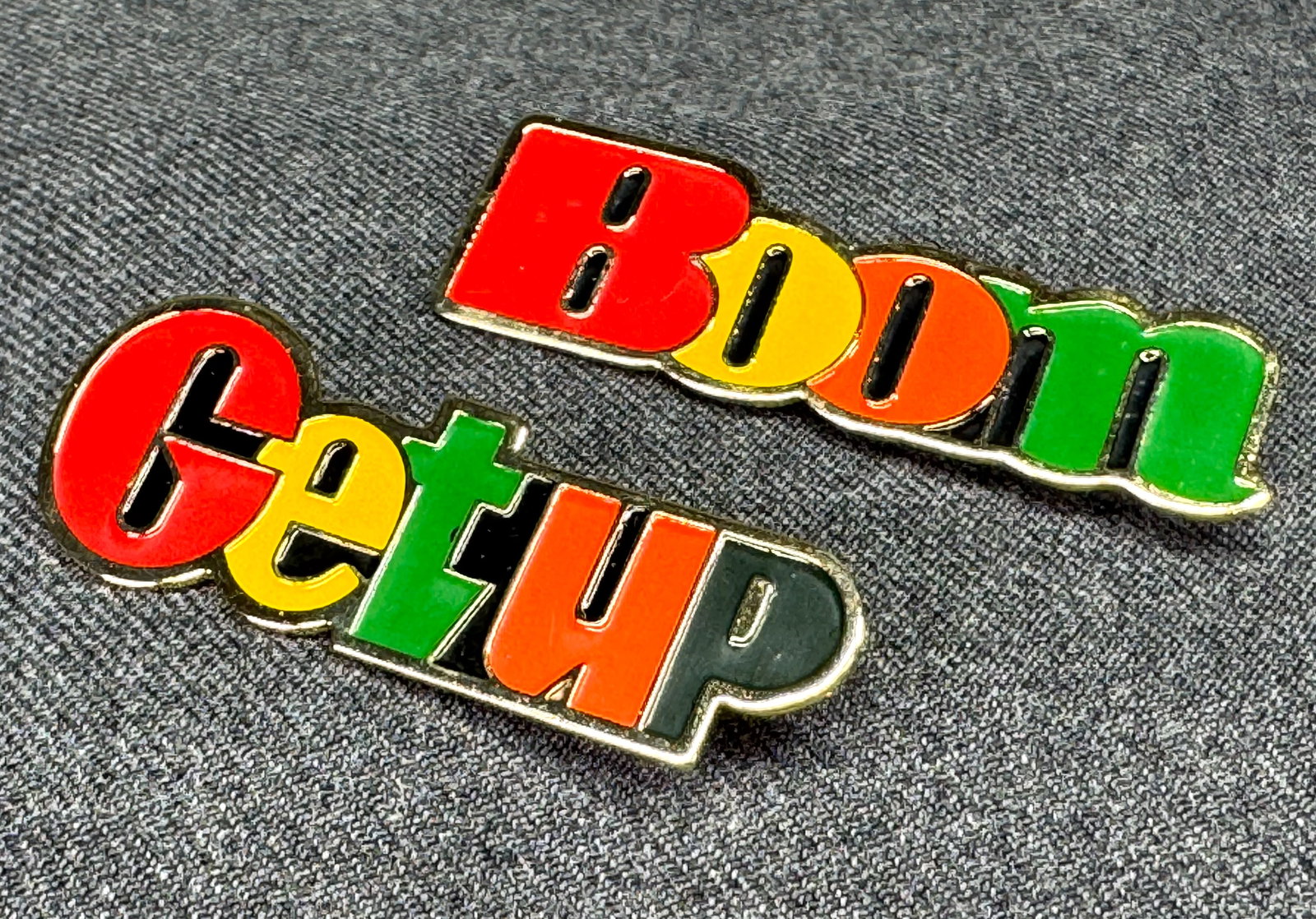 Vintage 80s. "BOOM" & "GETUP" brooch pins. Enamel, gold-toned. *e: Vintage 80s. "BOOM" & "GETUP" brooch pins. Enamel, gold-toned. Unmarked . For measures please refer to the pictures that were taken with a measuring tape. Weight: 12 Grams. IN HOUSE FLAT SHIPPING & HA