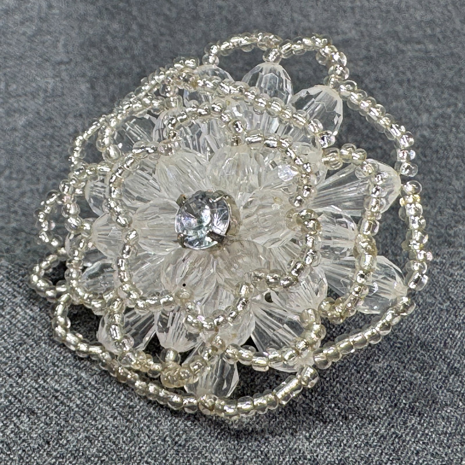 Vintage artisan crystal beaded flower oversized adjustable ring. 2 Inches. *e: Vintage artisan crystal beaded flower oversized adjustable ring. 2 Inches in diameter. Silver-toned. Unmarked. For measures please refer to the pictures that were taken with a measuring tape. Weight: 