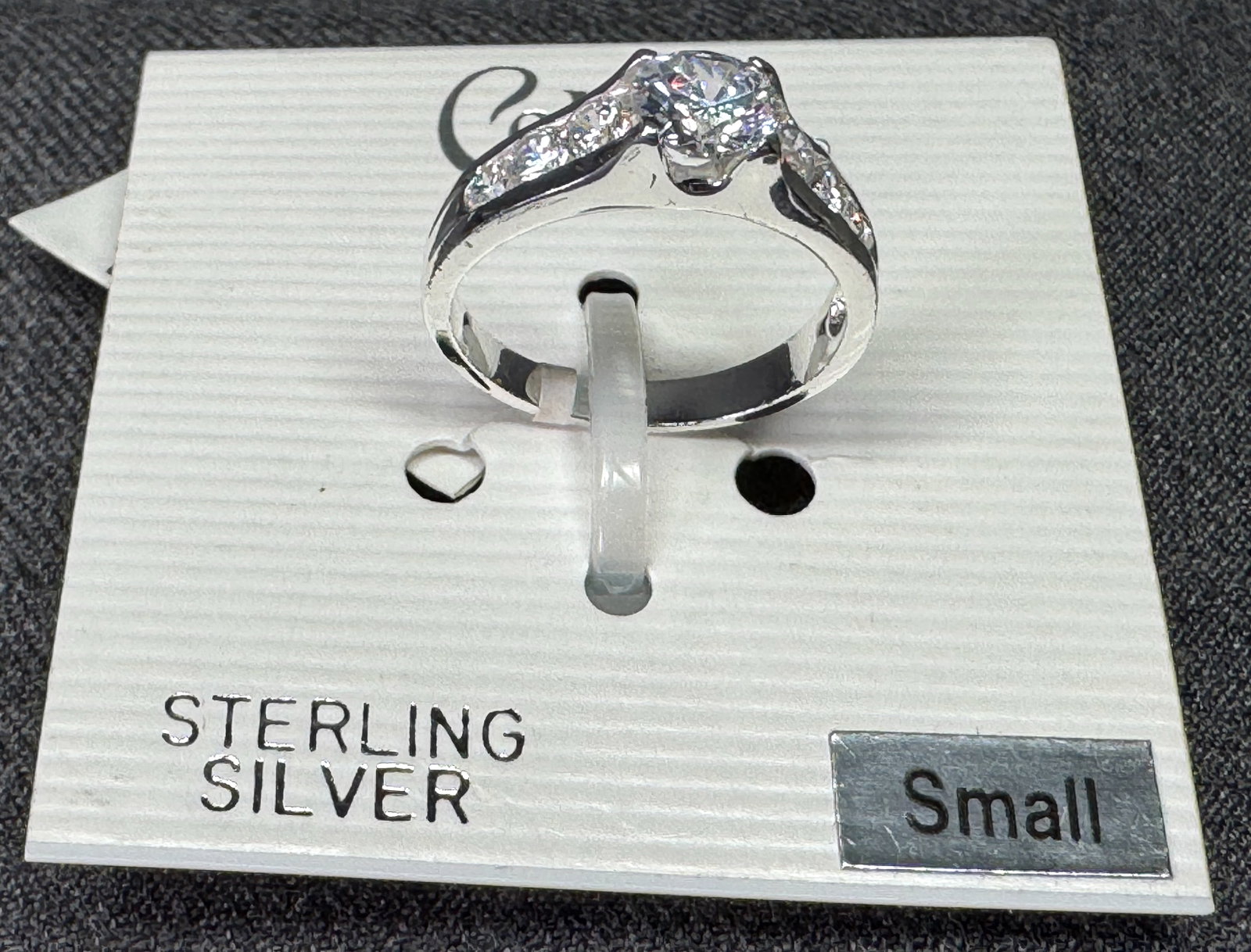 Cellini CZ sterling silver ring. Silver-toned . Unused in card. *e: Cellini CZ sterling silver ring. Cubic zirconia, Silver-toned . Unused in card. Size small. For measures please refer to the pictures that were taken with a measuring tape. Weight:5 Grams. IN HOUSE FL