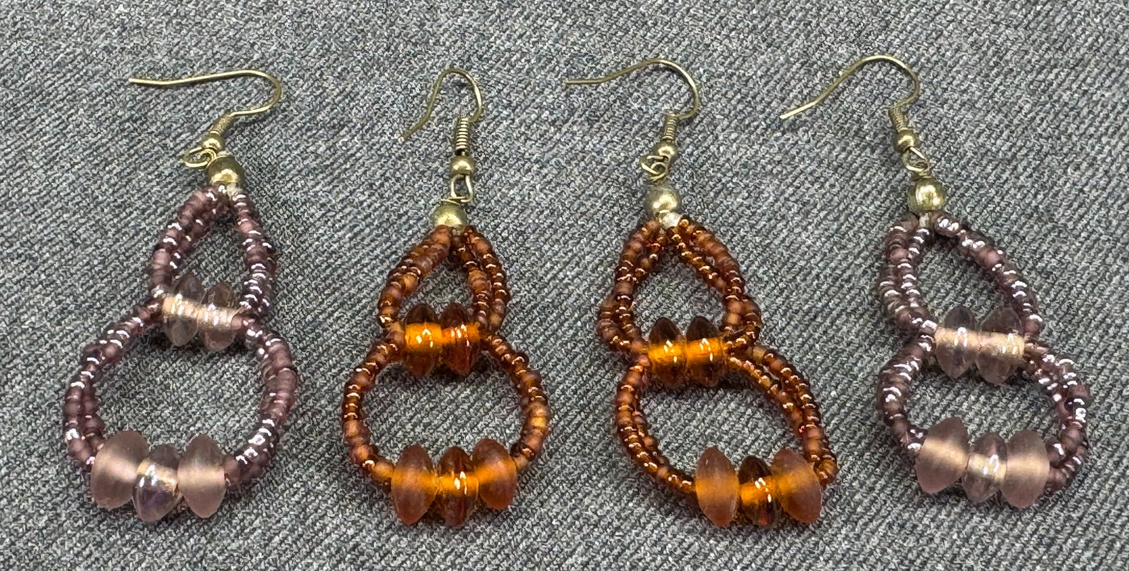 Vintage boho assorted glass beaded drop hook earrings. Lot of 2: Vintage boho assorted glass beaded drop hook earrings. Lot of 2. Unmarked. For measures please refer to the pictures taken with a measuring tape. Weight: 12 Grams . IN HOUSE FLAT SHIPPING & HANDLING C
