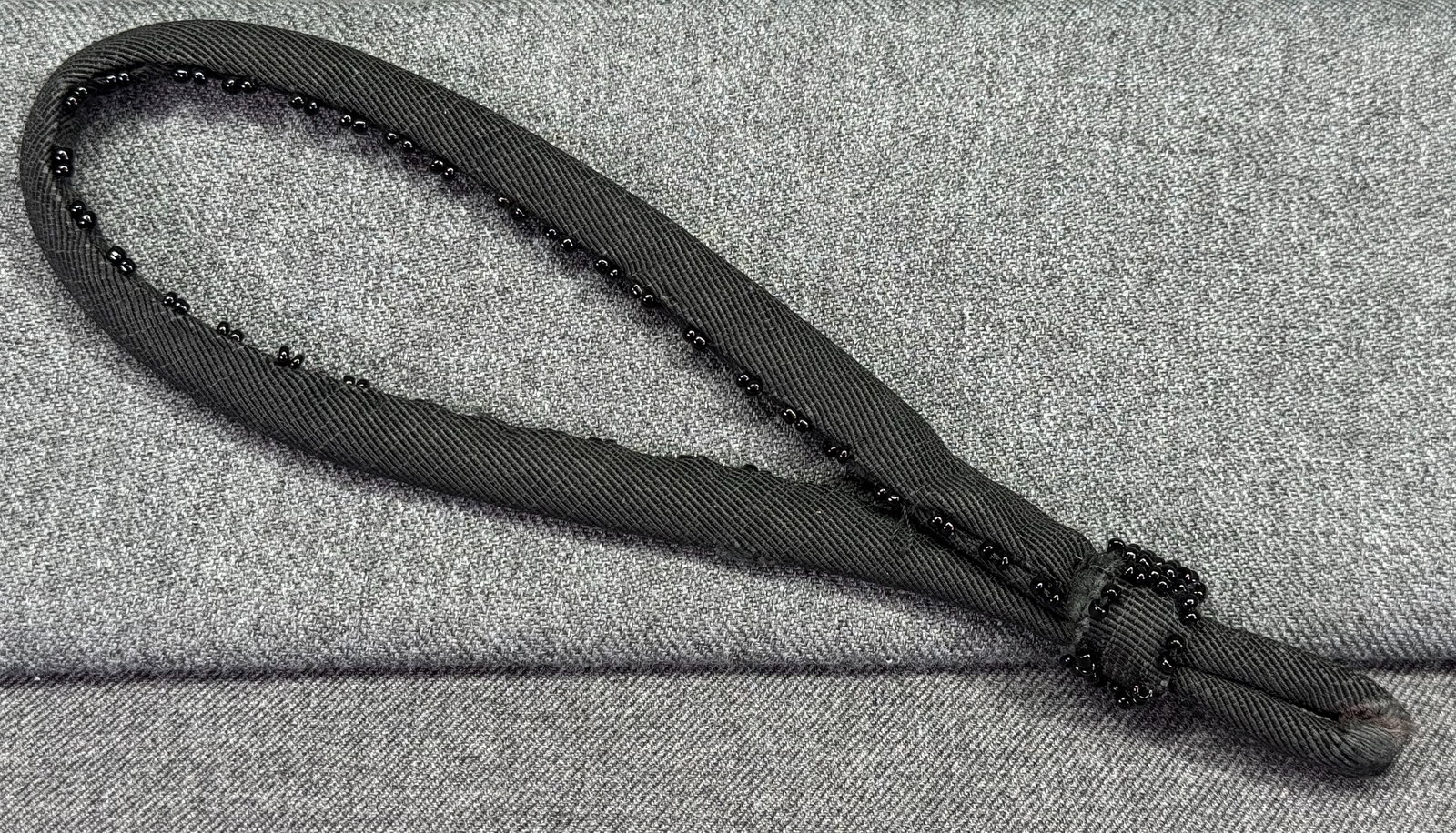 Antique Edwardian black beaded fabric purse handle or millinery applique: Antique Edwardian black beaded fabric purse handle or millinery applique. For measures please refer to the pictures taken with a measuring tape. Weight: 12 Grams . IN HOUSE FLAT SHIPPING & HANDLING CO