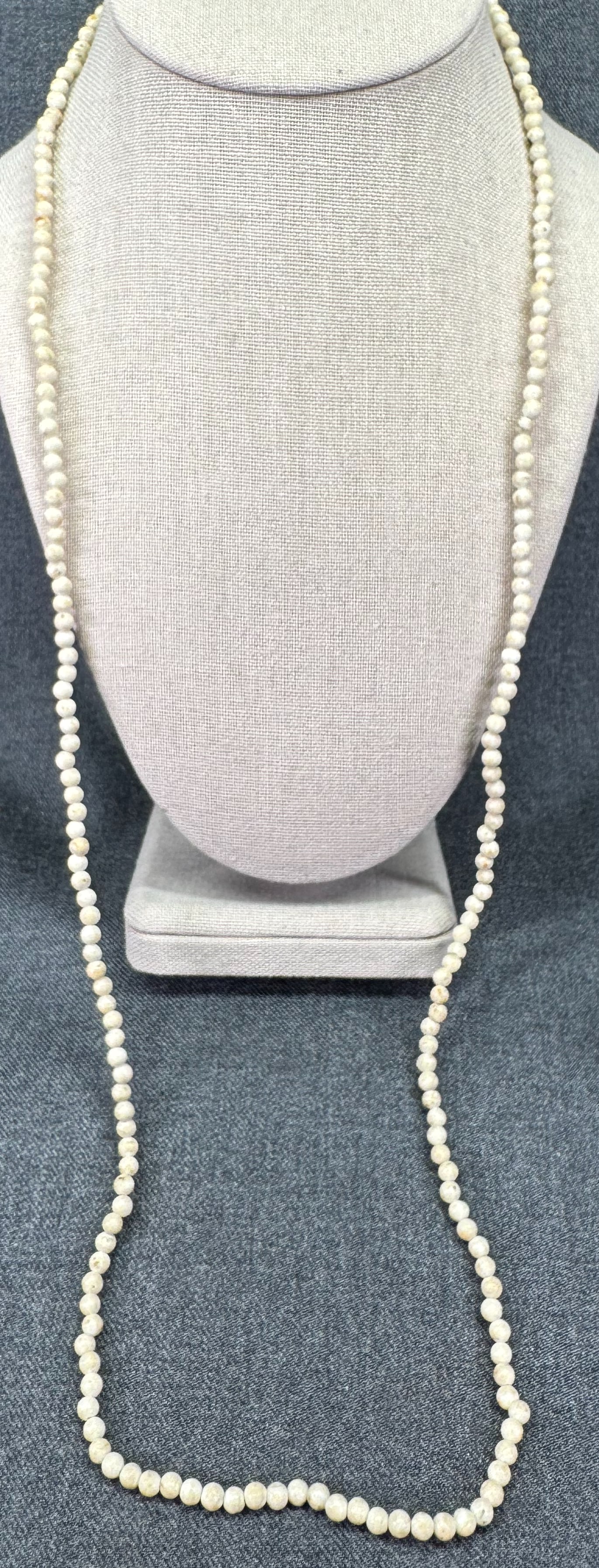 Vintage creamy reconstituted stone beads necklace. *a: Vintage creamy reconstituted stone beads necklace. Unmarked. For measures please refer to the pictures taken with a measuring tape. Weight: 22 Grams IN HOUSE FLAT SHIPPING & HANDLING COST WITHIN ALL T