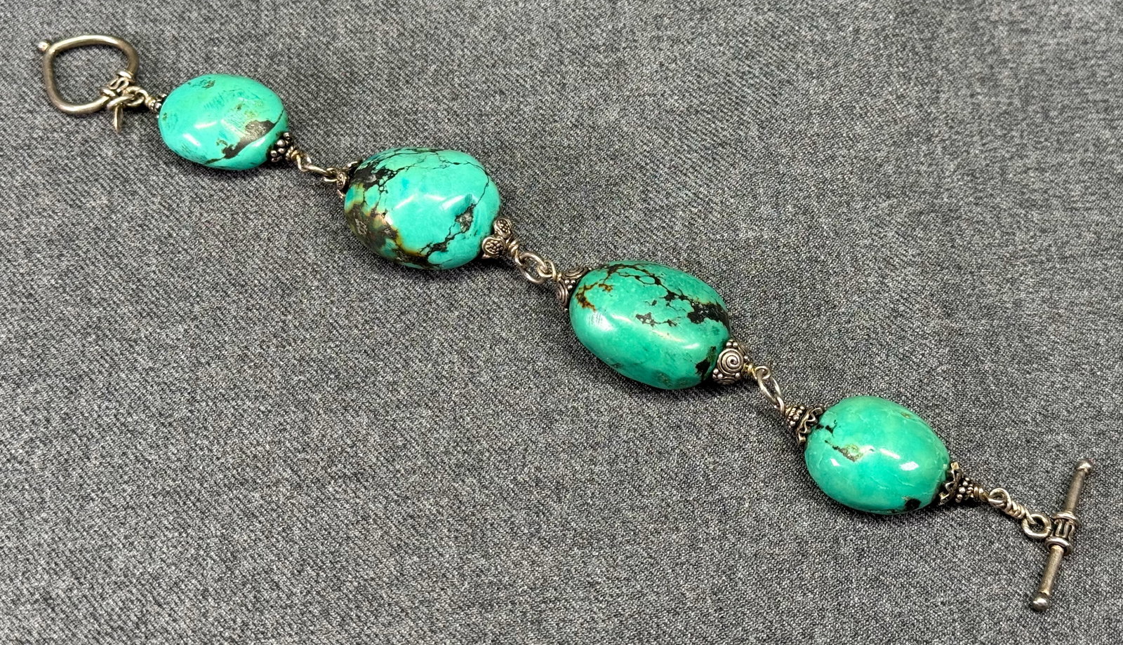 Vintage stabilized turquoise sterling silver bracelet. Marked Zenia *d: Vintage stabilized turquoise sterling silver bracelet. Marked Zenia, unmarked for sterling. For measures please refer to the pictures taken with a measuring tape. Weight: 52 Grams. IN HOUSE FLAT SHIPP