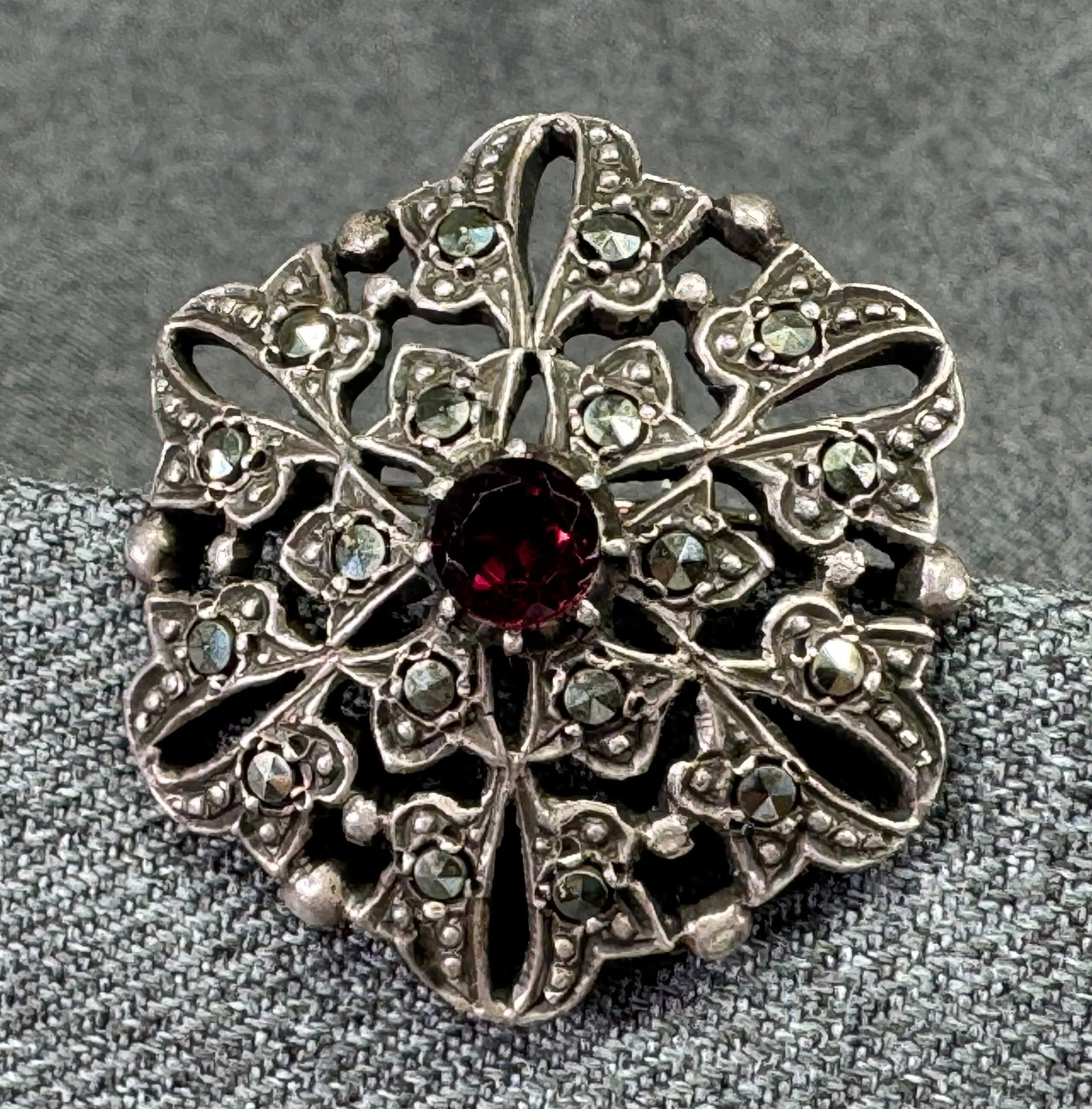 Antique Art Deco Openwork Flower Brooch Pin. Garnet, Marcasite, 800 Silver. *h: Antique European Art Deco Openwork Flower Brooch Pin. Garnet, Marcasite, 800 Silver. Unmarked. For measures please refer to the pictures taken with a measuring tape. Weight: 12.72 Grams. IN HOUSE FLAT