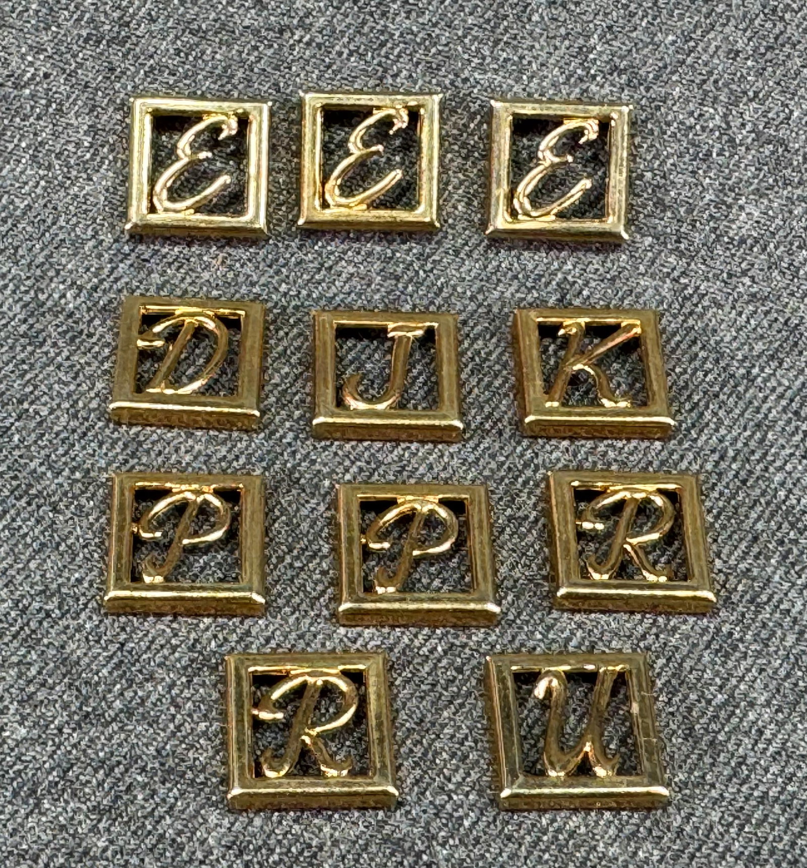 Vintage assorted letter initial gold-toned appliques embellisments. Lot of 11: Vintage assorted letter initial gold-toned appliques embellisments. Lot of 11. Unused. For measures please refer to the pictures taken with a measuring tape. Weight: 11 Grams. IN HOUSE FLAT SHIPPING &