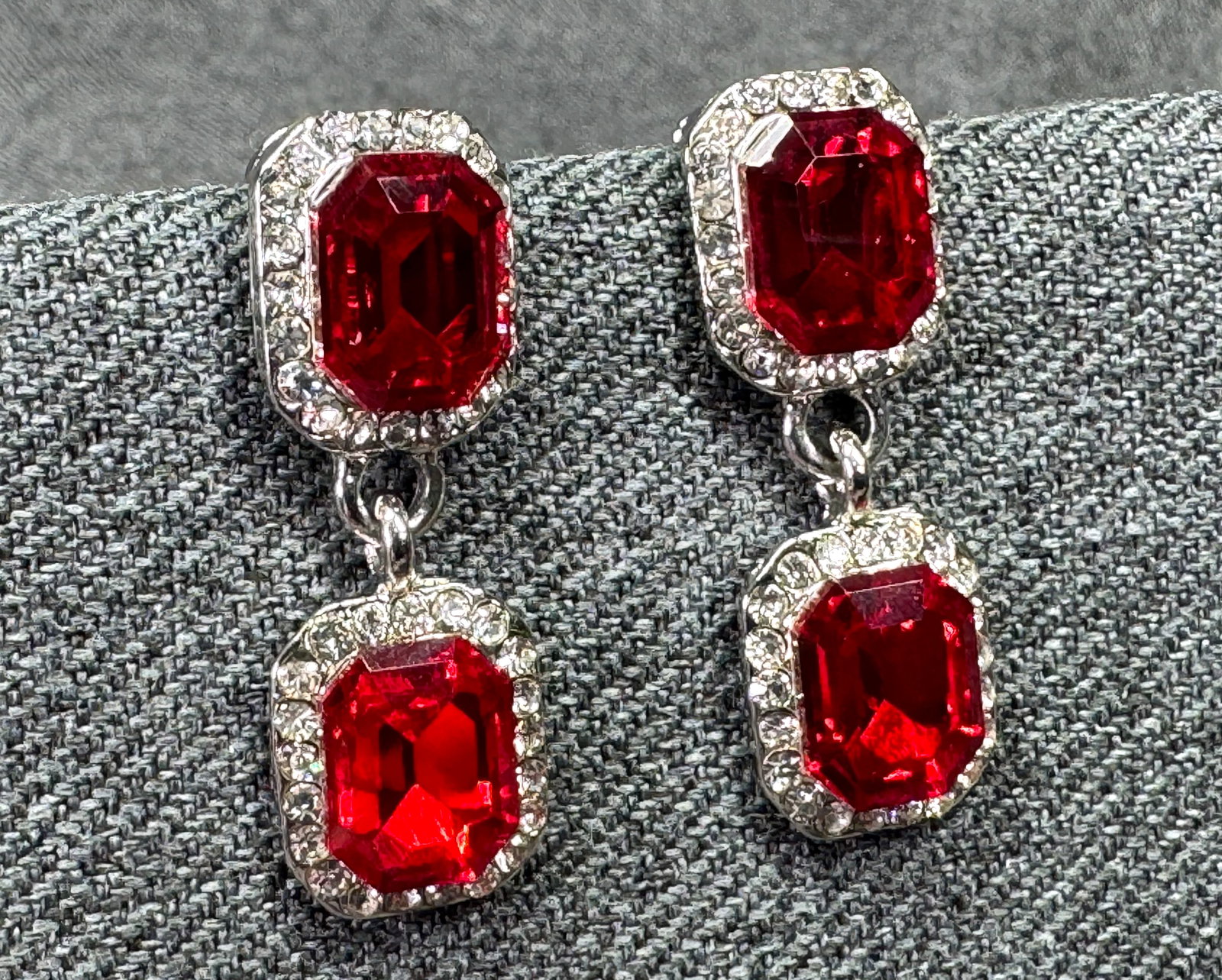 Vintage-style emerald-cut red crystal drop earrings. 1x*h: Vintage-style emerald-cut red crystal drop stud earrings. Clear rhinestones. Silver-toned. For measures please refer to the pictures taken with a measuring tape. Weight: 9 Grams. IN HOUSE FLAT SHIPPIN