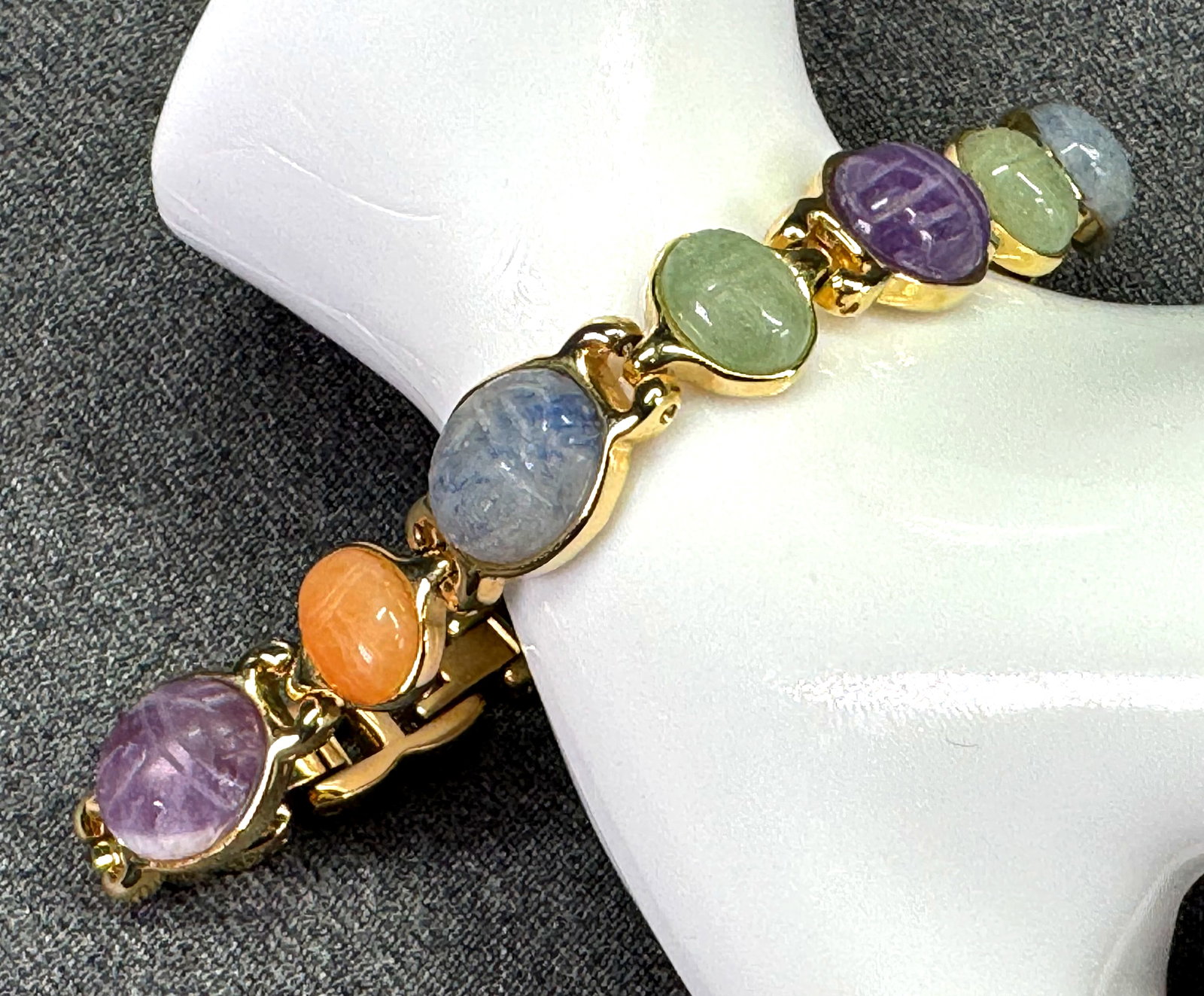 Egyptian Revival Carved Multi Gemstone Scarab Link Bracelet . Adjustable. *J: Egyptian Revival Carved Multi Gemstone Scarab Link Bracelet . Adjustable. Gold-tone. Unmarked. Smallest Size: Around 6.75 inches (with links removed). Middle Size: Around 7.25 inches (with one link ad
