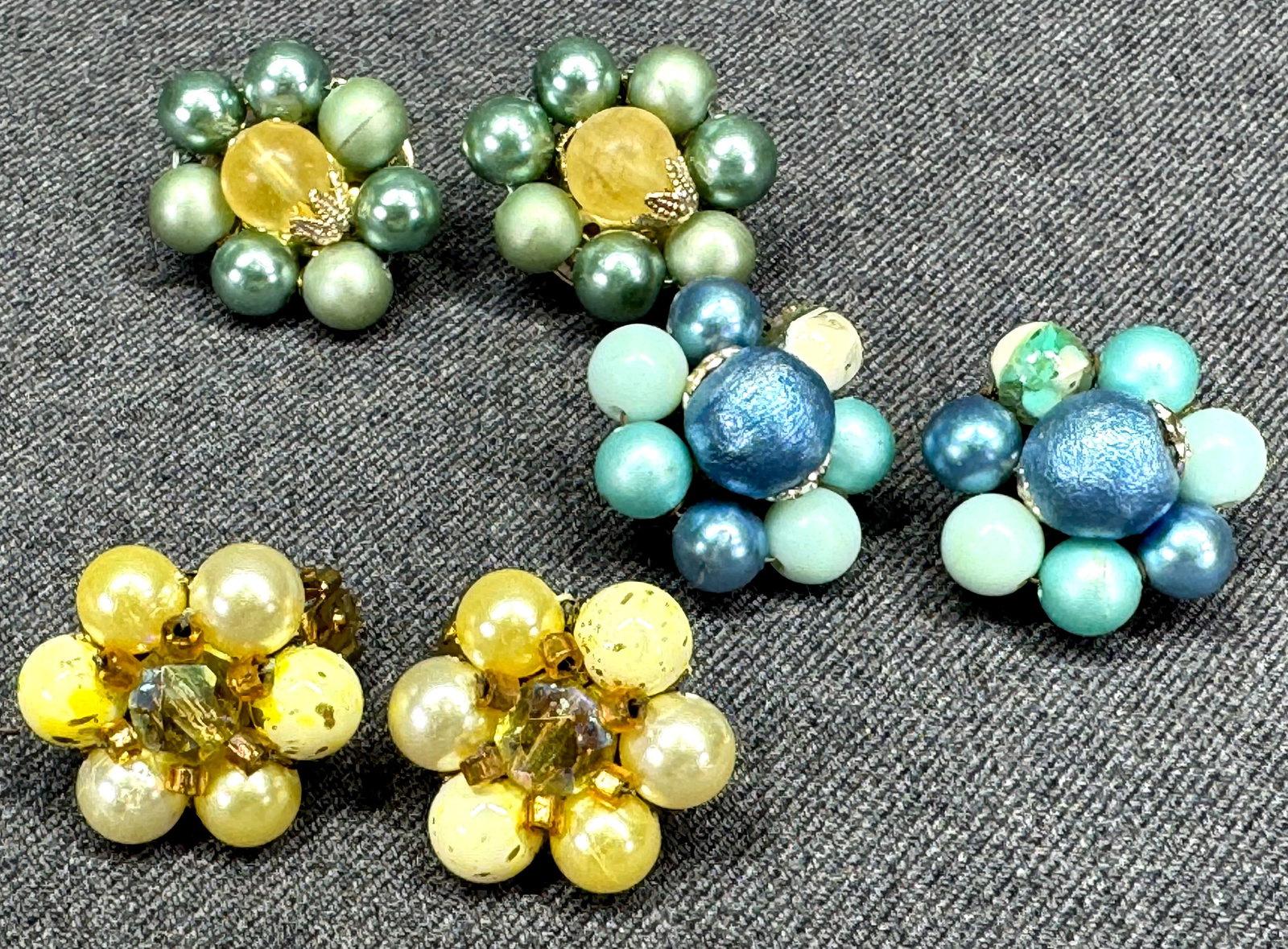 Vintage Japanese bluish, yellowish & greenish pearly cluster flower earrings: Vintage Japanese bluish, yellowish & greenish pearly cluster flower earrings. Marked Japan on clasp. For measures please refer to the pictures taken with a measuring tape. Weight: 30 Grams . IN HOUSE 