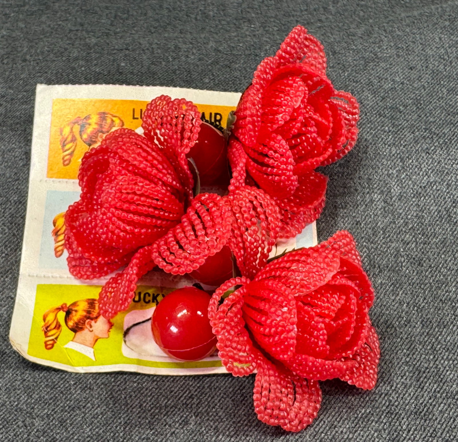 Vintage red plastic flower elastic band pony tail hair holder. Unused in card. Lot of 3: IN HOUSE FLAT SHIPPING & HANDLING COST WITHIN ALL THE U.S. : $8 To bypass LiveShipping, and use our In-House shipping service for $8 or shipping combined for multiple lots, please select “Arrang