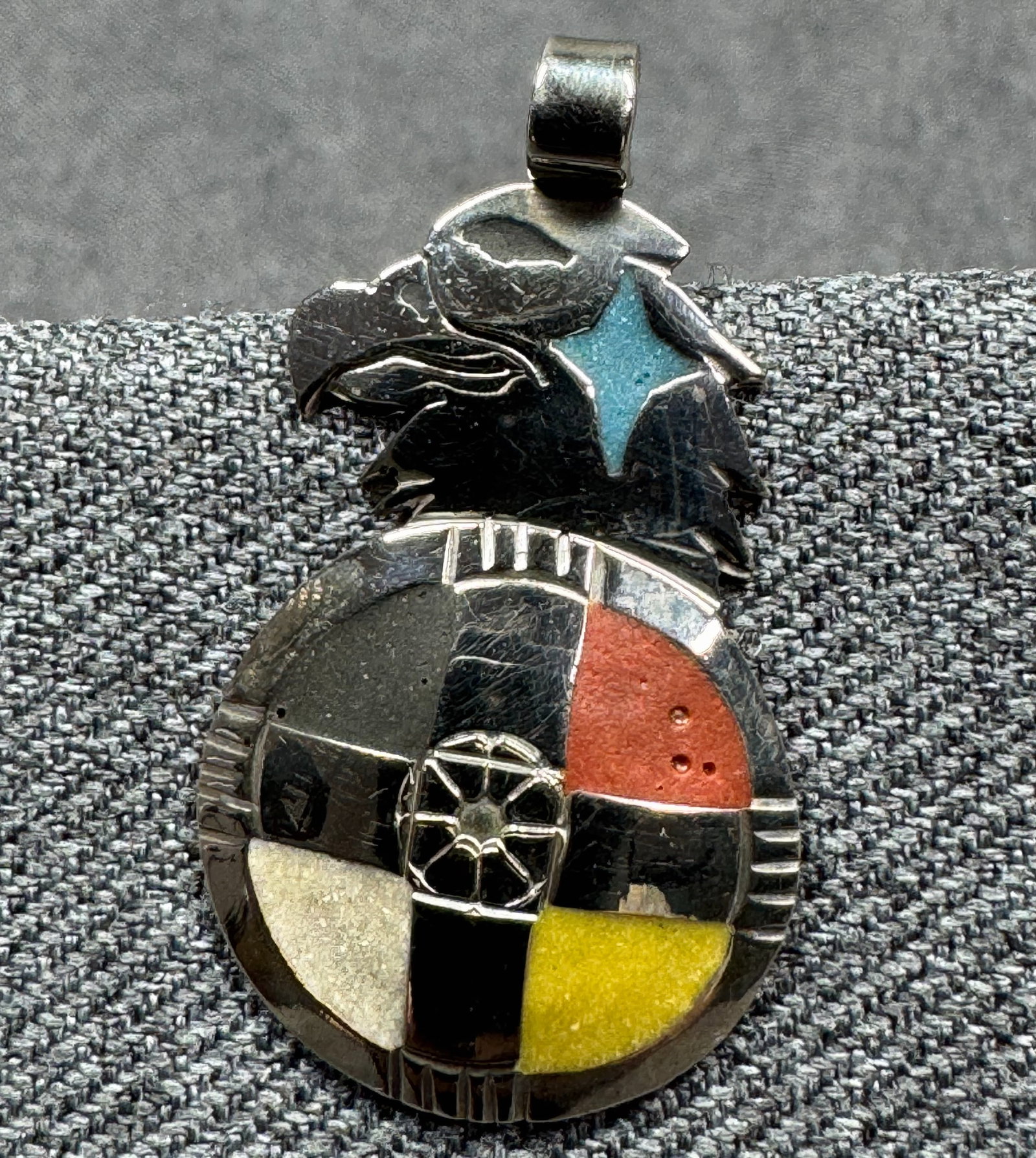 Vintage 80s Mitchell Zephier Lakota Native American Eagle Medicine Wheel Pendant. *K: Lakota Mitchell Zephier Native American Eagle Medicine Wheel Pendant. German Silver, Crushed Stones Channel Inlay of red pipestone, black pipestone, yellow sandstone, white alabaster, and turquoise. M