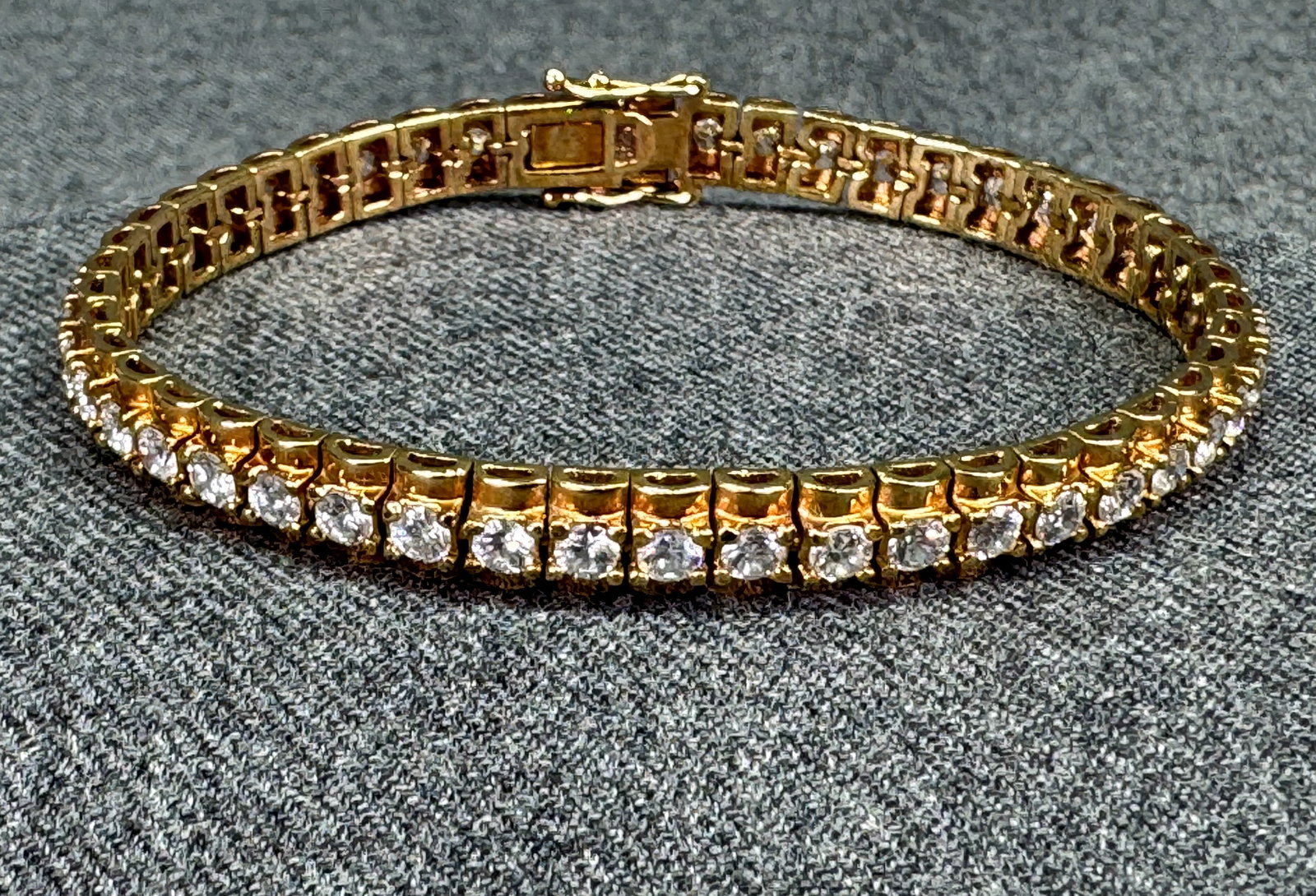 Gilt Sterling Silver Moissanite Tennis Bracelet *j: Gilt Sterling Silver Moissanite Tennis Bracelet. Marked 925. For measures please refer to the pictures taken with a measuring tape. Weight: 16.47 Grams IN HOUSE FLAT SHIPPING & HANDLING COST WITHIN AL