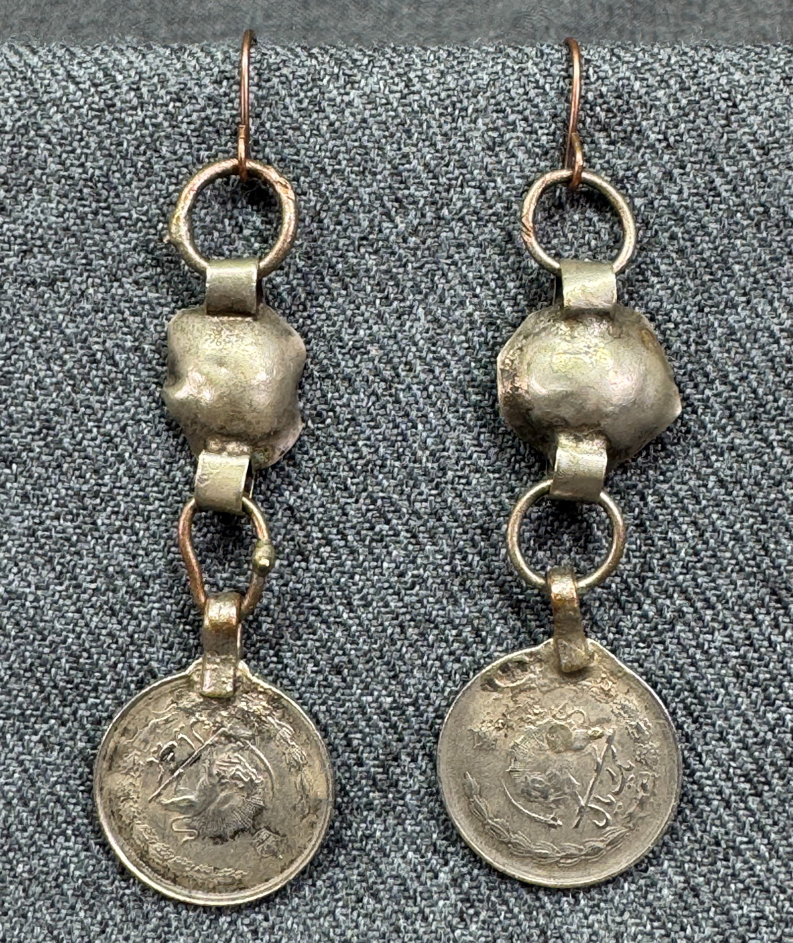 Vintage tribal Kuchi silver coin dangle hook earrings. *d: Vintage tribal Kuchi silver coin dangle hook earrings. Unmarked. For measures please refer to the pictures taken with a measuring tape. Weight: 7 Grams. IN HOUSE FLAT SHIPPING & HANDLING COST WITHIN A