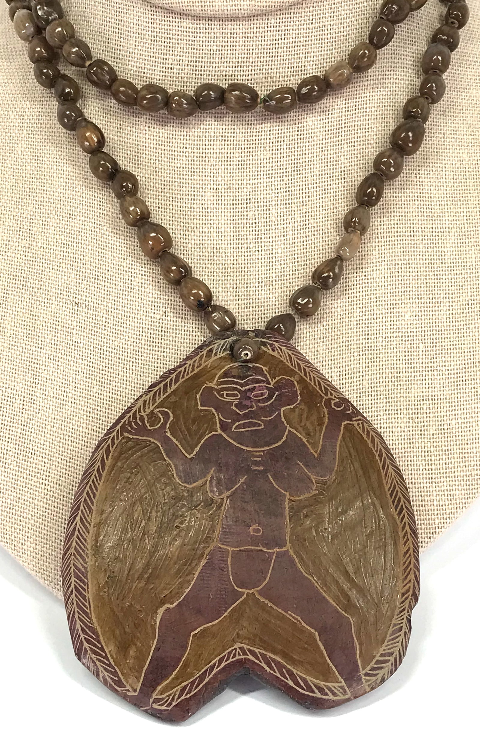 Papua New Guinea Asaro Painted and Incised Stone Medallion & Seeds Strap Necklace.