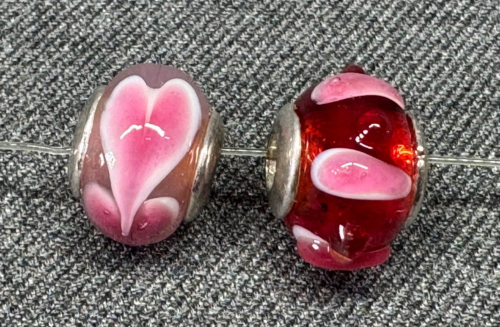 Vintage artisan assorted glass silver rim beads charms. Lot of 2