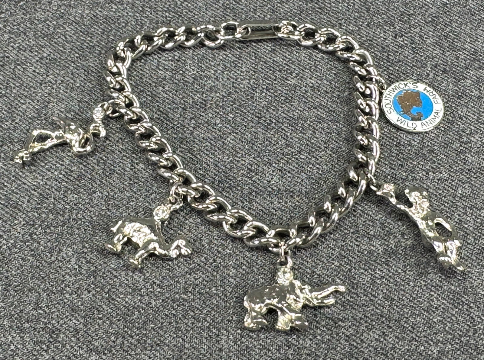 Vintage Southwick’s Wild Animal Farm Souvenir Charm Bracelet . *M: Vintage Southwick’s Wild Animal Farm Souvenir Charm Bracelet. Enamel medal & 4 animal jeweled clear Crystal charms. Silver-tone. Unmarked. For measures please refer to the pictures taken with a meas