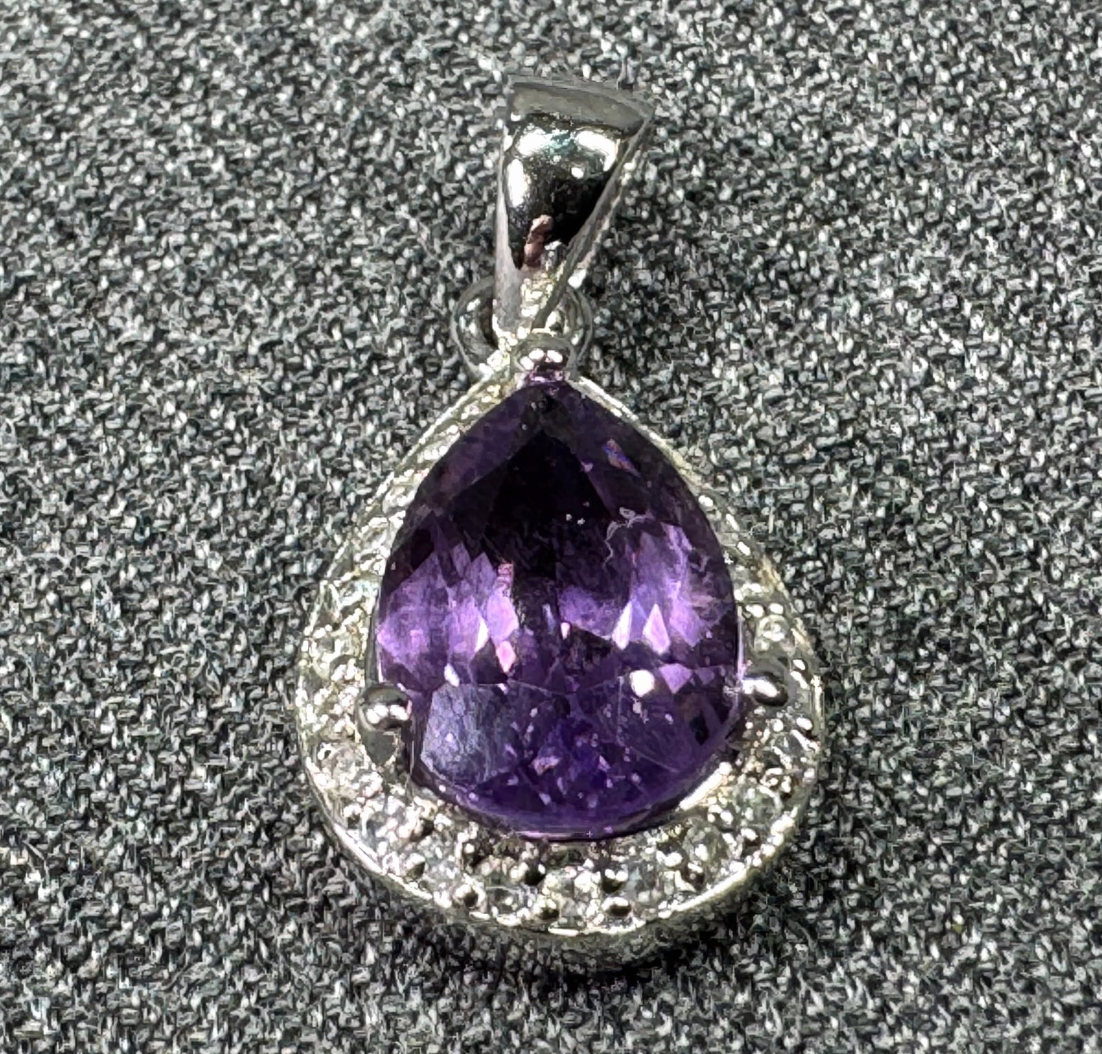 Sterling Silver Pear Cut Amethyst Cz Halo Pendant. Marked FAS 925. *L: Sterling Silver Pear Cut Amethyst Cz Halo Pendant. Marked FAS 925. For measures please refer to the pictures taken with a measuring tape. Weight: 3.04 Grams. IN HOUSE FLAT SHIPPING & HANDLING COST WIT
