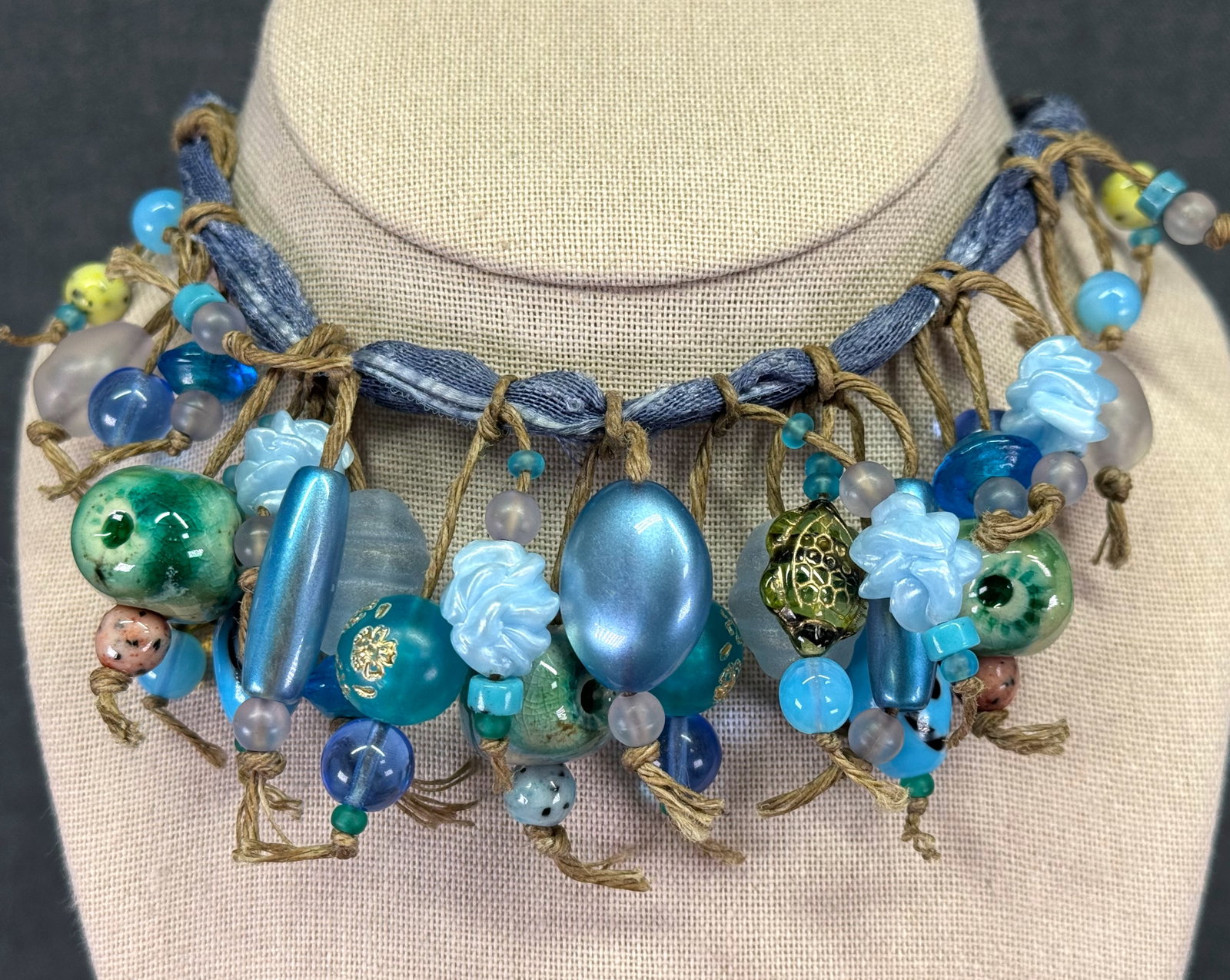 Artisan Handcrafted Boho Statement Charm Necklace. Fabric Ribbon. *J: Artisan Handcrafted Boho Statement Pottery, Glass & Resin Charm Necklace. Fabric Ribbon Unmarked. For measures please refer to the pictures taken with a measuring tape. Weight: 80 Grams. IN HOUSE FLAT