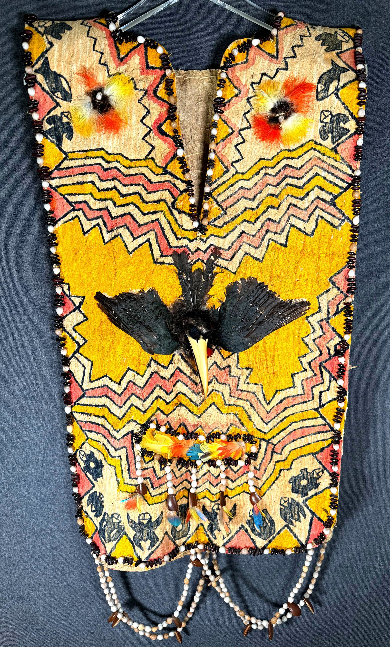 Amazonian Jivaro Shaman’s Vest: Amazonian Jivaro Shaman’s Vest.Painted bark, feathers, toucan heads and wings, seeds. It measures 34 inches long end to end and 17 1/2 inches widest. Ex Collection Howard Gelb, Saint Paul, Minne