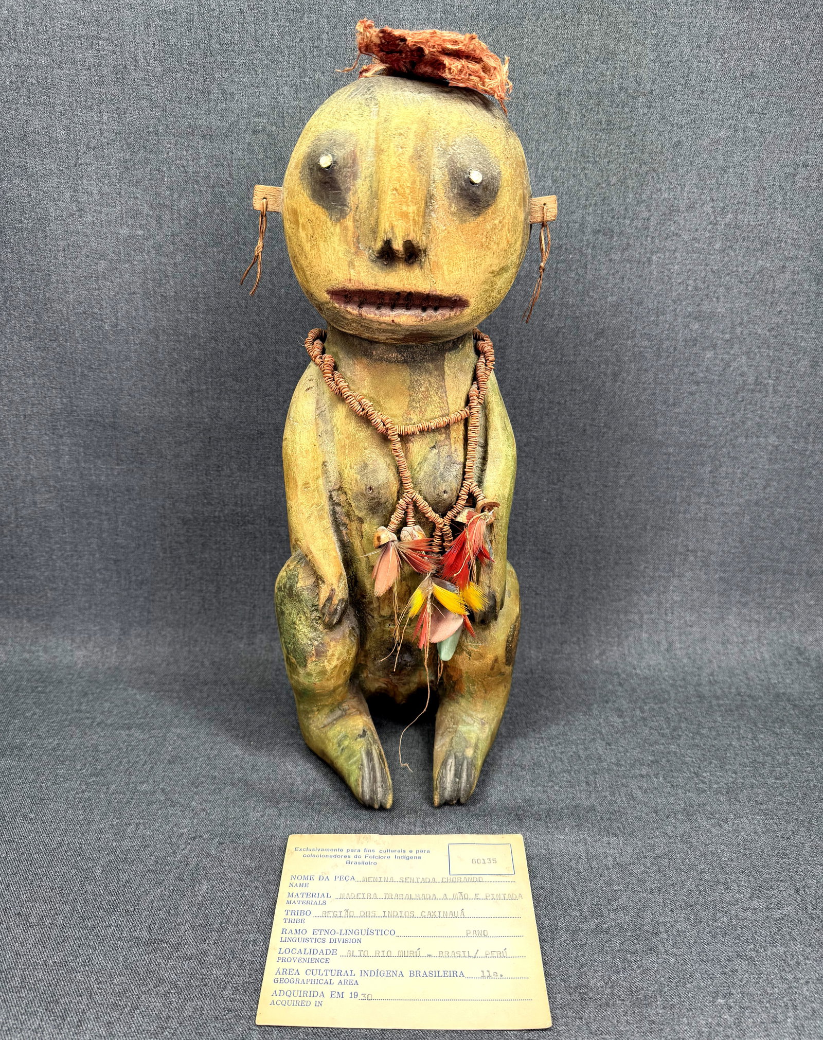 Antique Amazonian Caxinaua Figure. Coll. 1930 with COA: Antique Amazonian Caxinaua of the Alto Rio Muru “Menina Sentada Chorando” (Seated Girl Weeping) Figure. Carved wood, natural pigments, feathers, seeds, natural fibers. Certificate of authe