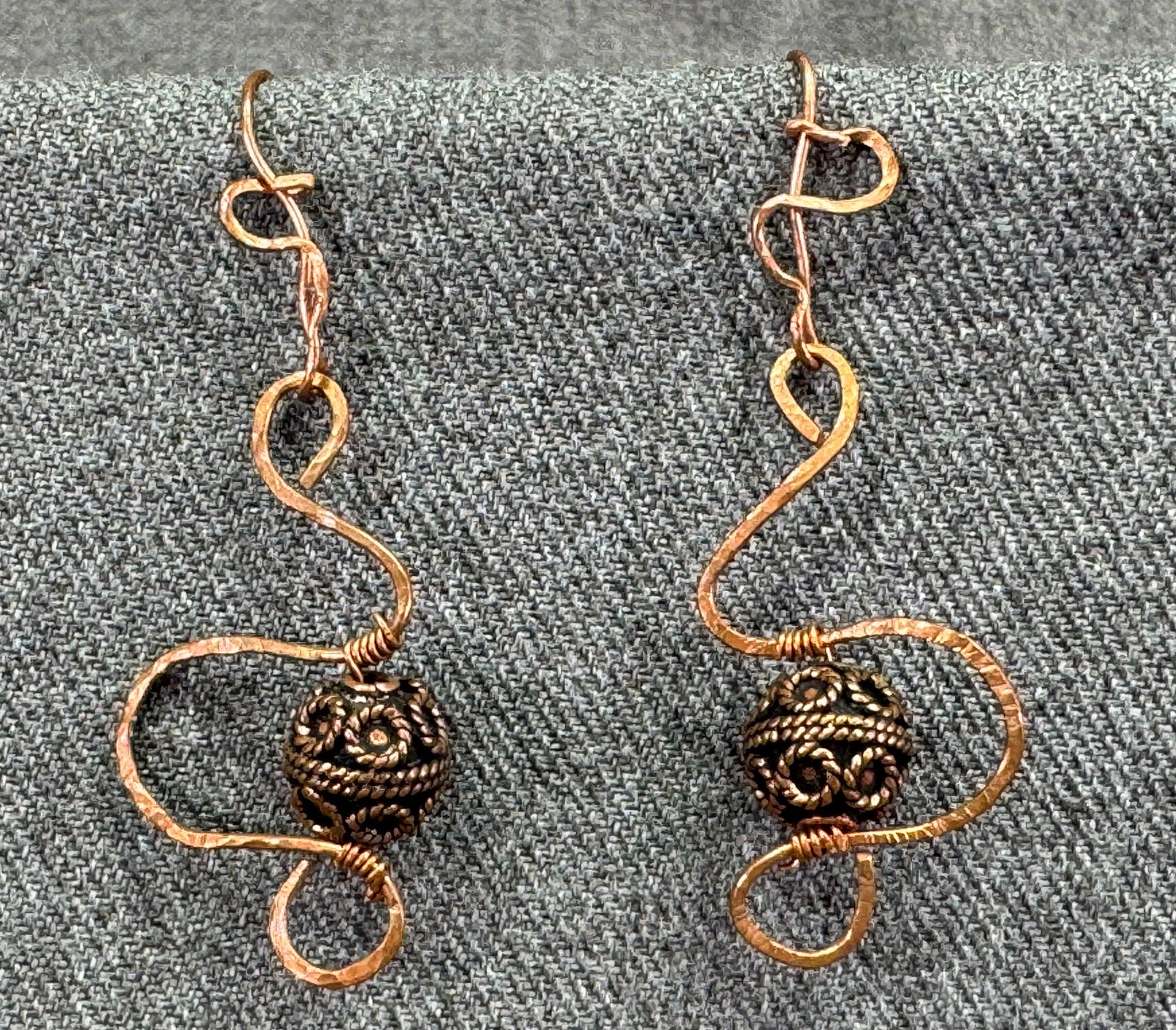 Vintage artsy brutalist copper gyro bead hook earrings: Vintage artsy brutalist copper gyro bead hook earrings. Unmarked. For measures please refer to the pictures taken with a measuring tape. Weight: 7 Grams. IN HOUSE FLAT SHIPPING & HANDLING COST WITHIN 