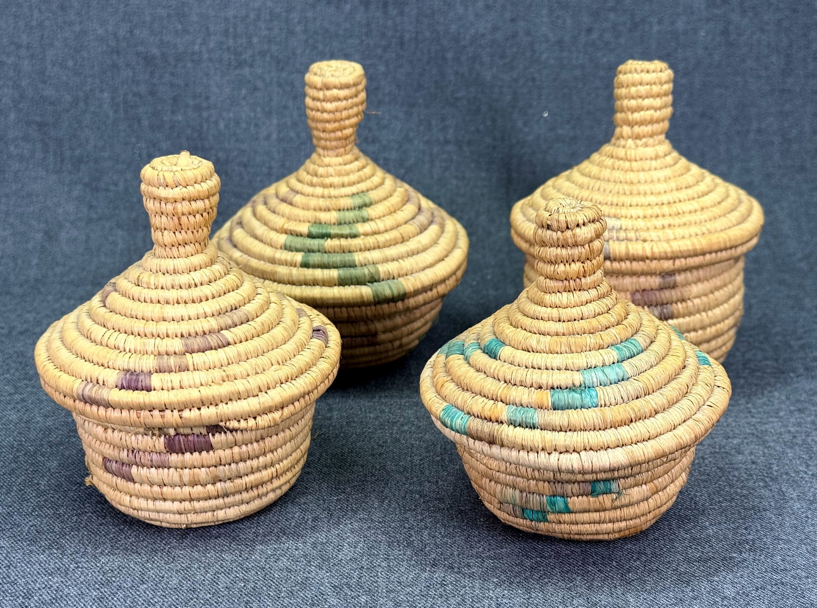 Vintage African Handwoven Polychrome Coiled Grass Lidded Basket. Lot of 4. *L: Vintage African Handwoven Polychrome Coiled Grass Lidded Basket. Lot of 4. For measures please refer to the pictures taken with a measuring tape. Weight: 250 Grams. IN HOUSE FLAT SHIPPING & HANDLING C