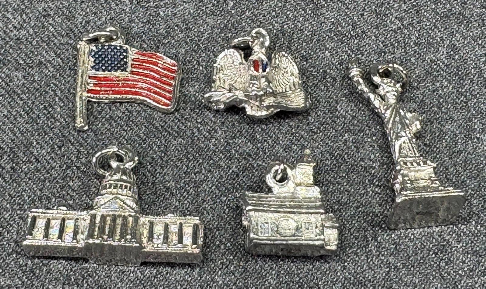 Vintage Dubarry Fifth Avenue & unmarked US patriotic charms. American Flag, Statue of Liberty, *d: Vintage Dubarry Fifth Avenue & unmarked silver-toned metal S patriotic charms. American Flag & Eagle are unmarked.U.S. Capitol Building, Statue of Liberty & House/Building are marked DFA. For measures
