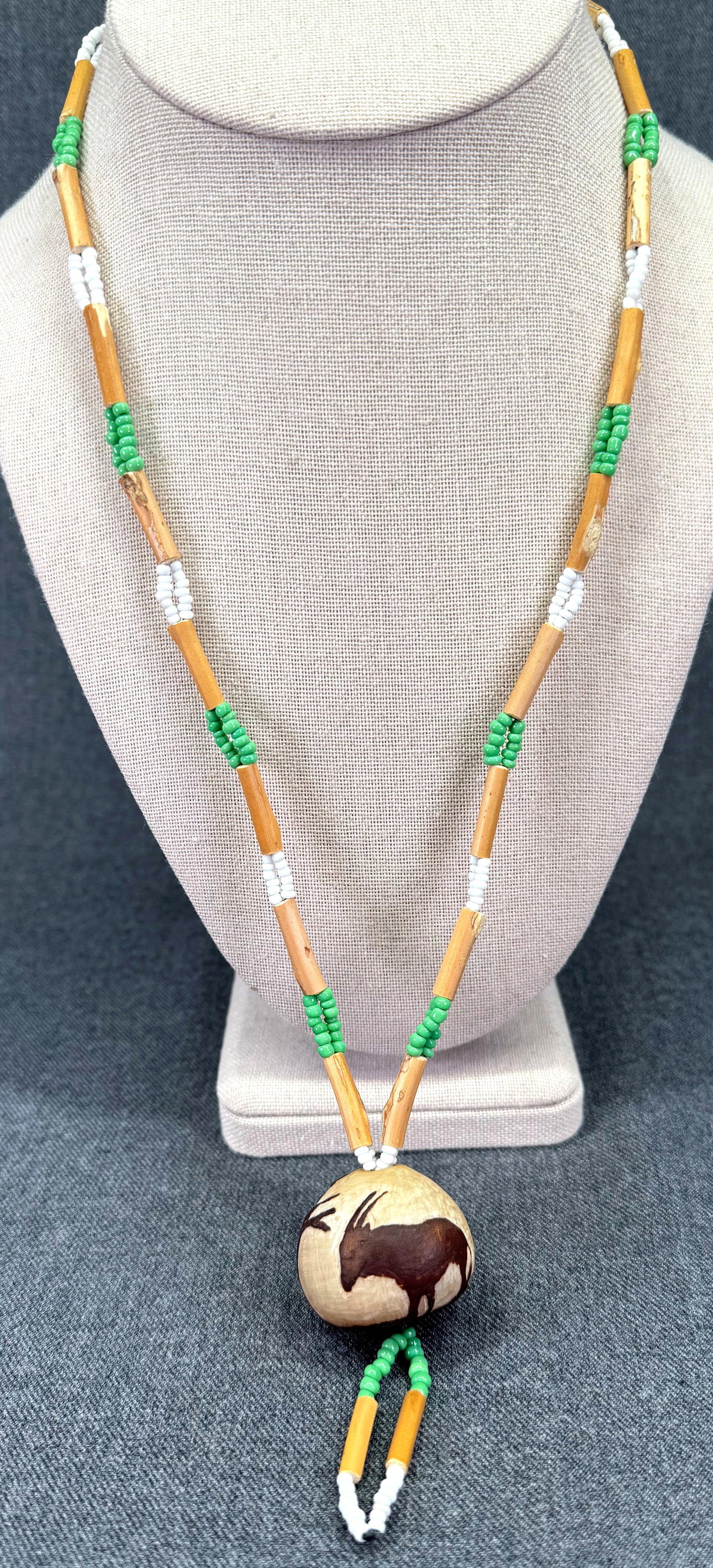 Vintage Hand Painted Antelope Resin? Pendant Necklace. Cane & Green Glass Beads. *L: Vintage Hand Painted Antelope Resin? Pendant Necklace. Cane & Green Glass Beads. Unmarked. For measures please refer to the pictures taken with a measuring tape. Weight: 29 Grams. IN HOUSE FLAT SHIPPI
