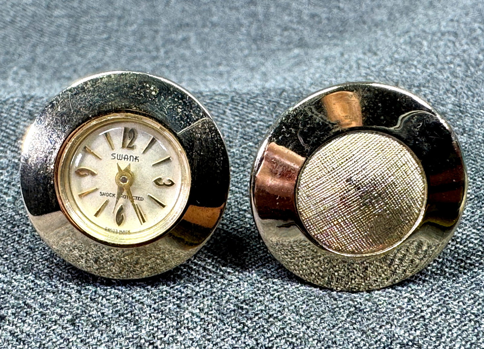 1950s Swank Fashion Time Swiss Watch Cufflinks. #n: Vintage 1950s/1960s Swank "Fashion Time" Swiss Watch Gold Filled Cufflinks. As is. Marked. For measures please refer to the pictures taken with a measuring tape. Weight: 21 Grams. IN HOUSE FLAT SHIPPI