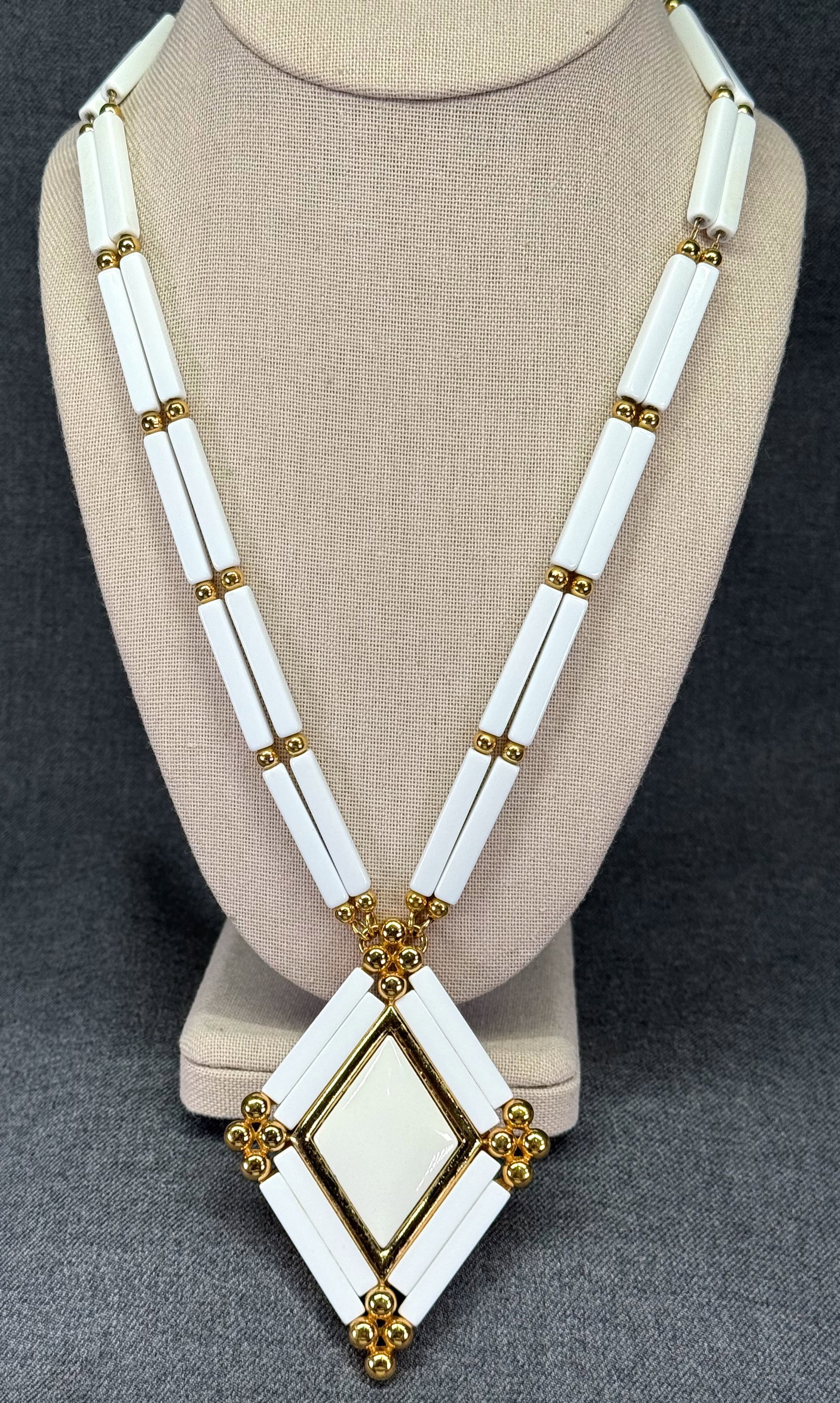 1980s Monet White Plastic Necklace. *o: Vintage 1980s Monet White plastic, gold-tone metal pendant necklace. Chain string. Marked. For measures please refer to the pictures taken with a measuring tape. Weight: 75 Grams. IN HOUSE FLAT SHIPPI