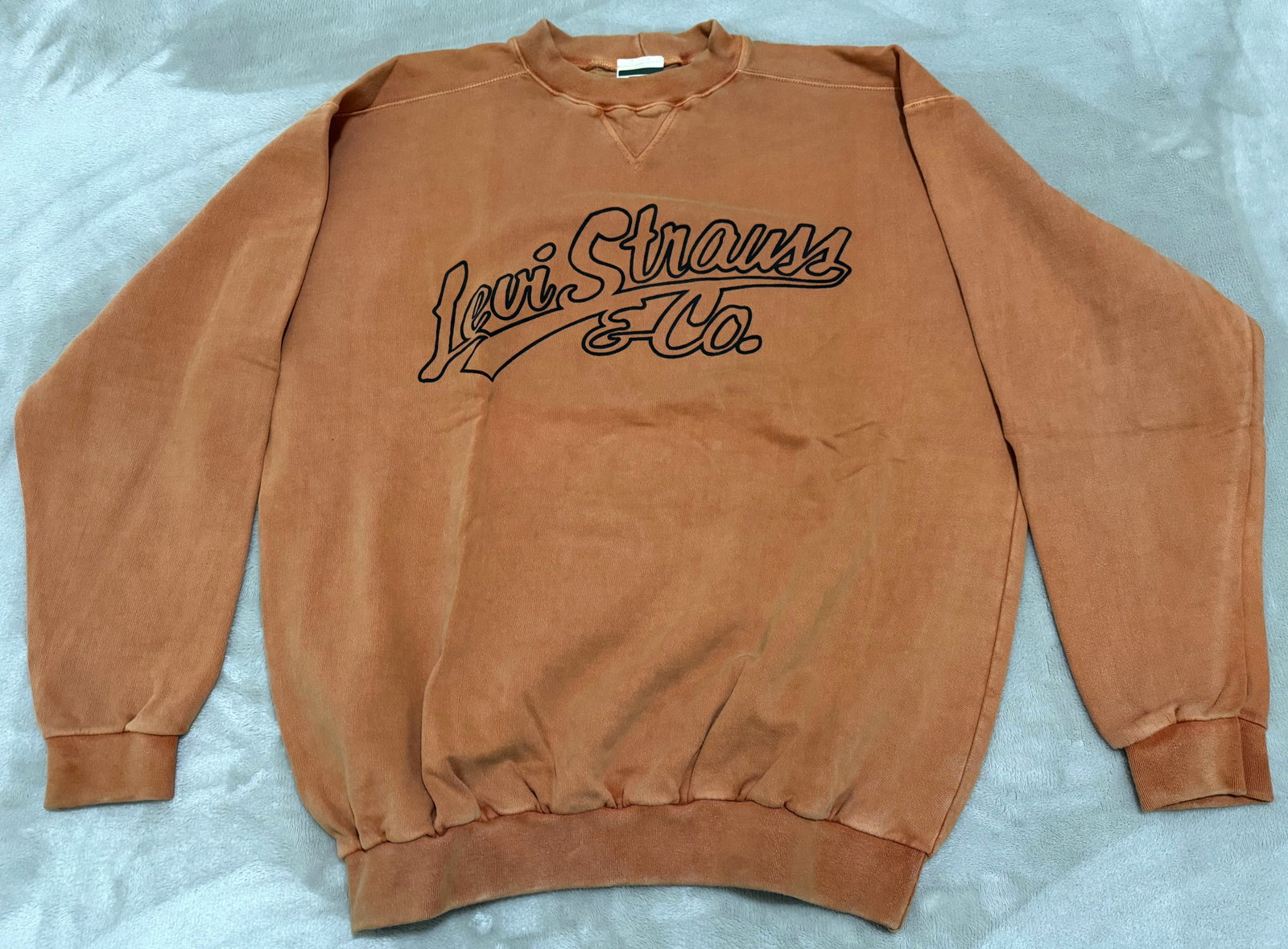 NOS 90s Vintage Levis Brown Script Graphic Crewneck Sweatshirt: Unused Features a large, bold dark-outlined script chest print highlighting the retro "Levi Strauss & Co." signature typography with a classic athletic stitched V-notch neckline and ribbed trim.True v