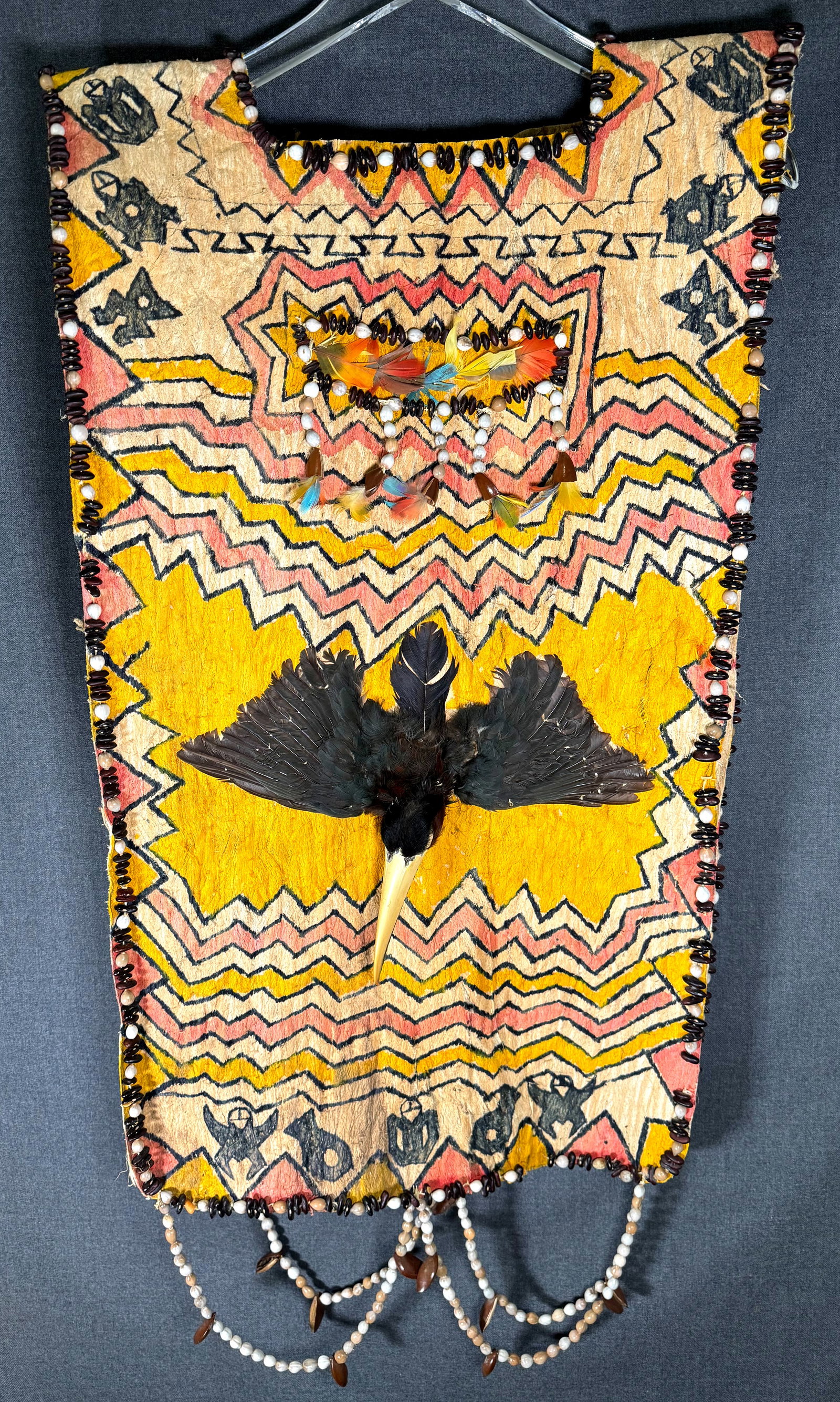 Amazonian Jivaro Shaman’s Vest: Amazonian Jivaro Shaman’s Vest.Painted bark, feathers, toucan heads and wings, seeds. It measures 34 inches long end to end and 17 1/2 inches widest. Ex Collection Howard Gelb, Saint Paul,