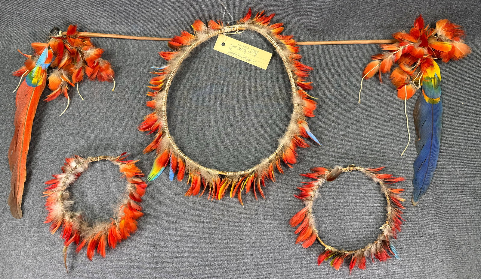 Amazonian Way - Way Set of Body Ornaments. Headdress, armbands, hair pins: Amazonian Way - Way Set of Body Ornaments. Feathers, wood, beeswax, fibers. Comprising: headdress, pair of armbands and pair of hair pins. ,br>The headdress with an old paper label from the FUNAI (