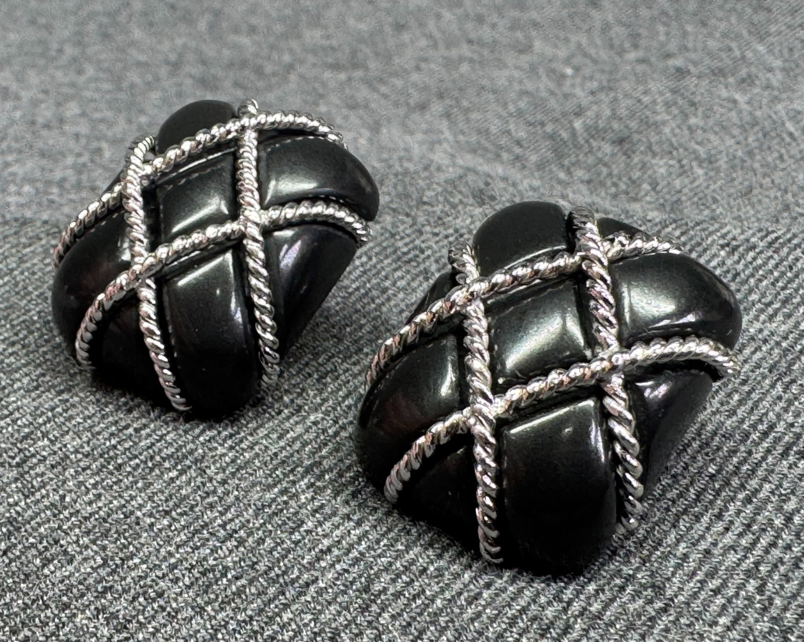 Vintage 1990s 18K White Gold Matte Black Onyx Clip Earrings. 28.35 Gr #p: Vintage 1990s clip-on earrings. Crafted in solid 18K white gold with carved matte black onyx cushion. Enveloped by a polished twisted rope quilted trellis design. Features convertible omega backs with