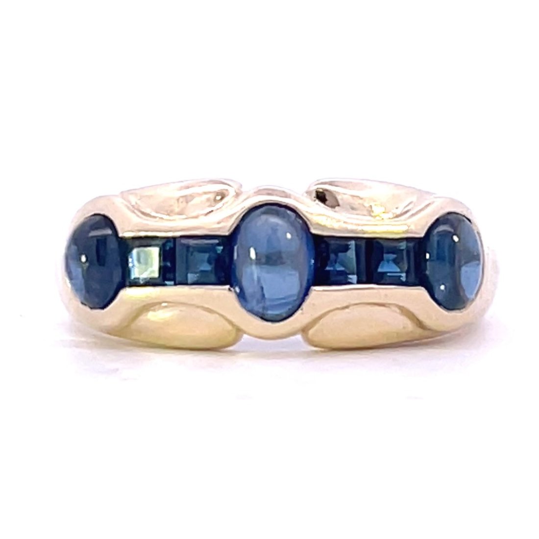 YELLOW GOLD SAPPHIRE RING: 14KT YELLOW GOLD RING WITH A BEAUTIFUL CHANNEL SET DESIGN WITH 3=0.83CTW OVAL CABACHON BLUE SAPPHIRES AND 4=0.28CTW SQUARE CUT BLUE SAPPHIRES.WEIGHING 3.7 GRAMS, SIZE 6.25