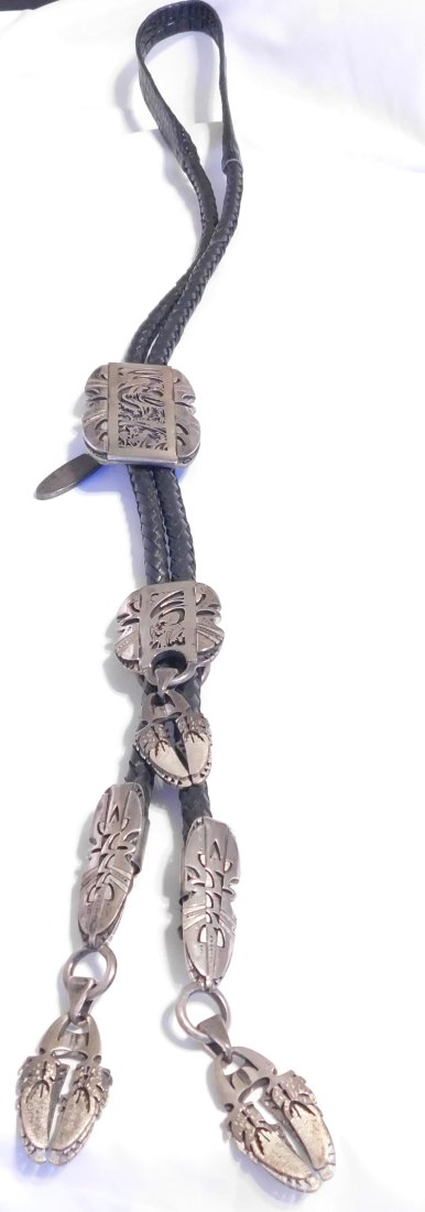 Native American Sterling Silver Heavy Bolo Tie With Cut Out Scene Signed: Thank you for your interest,For Sale is a Native American Sterling Silver Bolo Tie with Leather Straps.. This measures approximately 24" and has a weight of 204.0 Grams. This was a estate piece from a