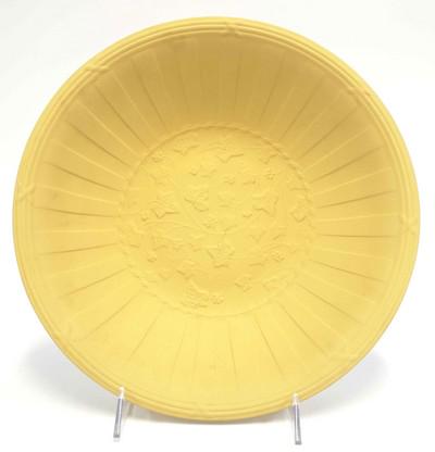 WEDGWOOD YELLOW JASPERWARE DORIC IVY BOWL: Wedgwood yellow jasperware Doric Ivy bowl featuring vine leaves in the bottom of the inside of the bowl. The bowl measures approximately 12 inches in diameter and stands around 2 3/4 inches tall. 2 lb