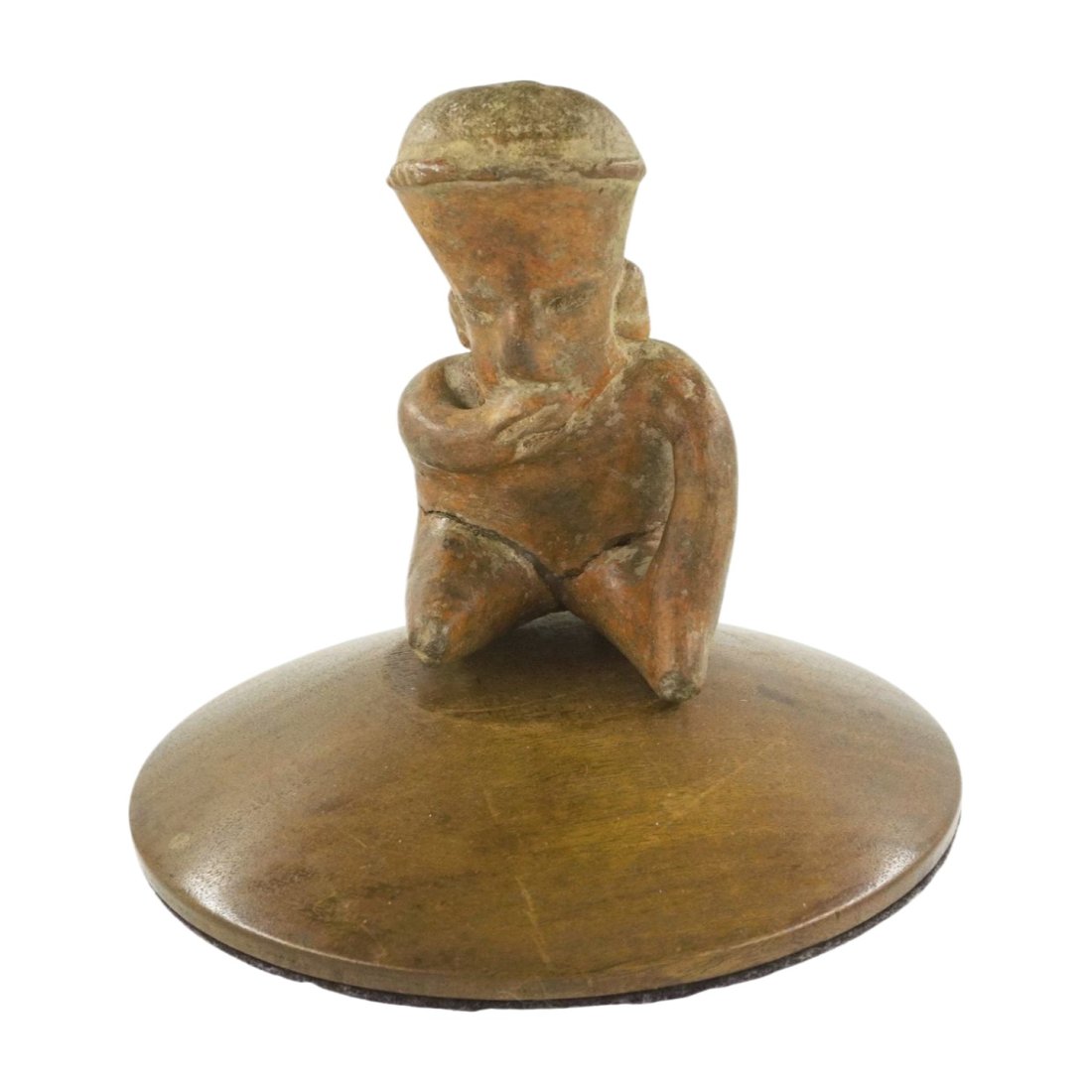 PRE-COLUMBIAN JALISCO COLIMA POTTERY FIGURE: Pre Columbian Pottery Seated Man. Western Mexico, Colima or Jalisco. Red Clay with a burnished red / brown slip\\. In a kneeling position with right hand covering mouth and left hand on leg. Opening o