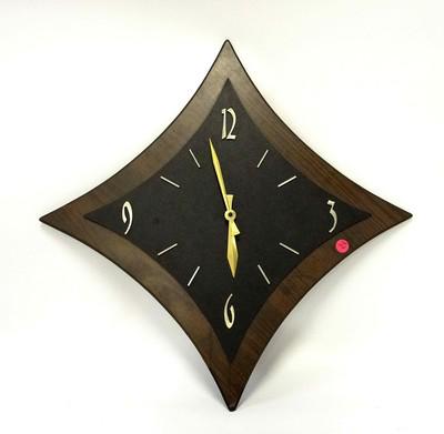 VINTAGE MCM WALL CLOCK: Vintage MCM Faux Wood with vinyl face plate and brass arms. Battery operated. 15"x15", 2 pds. 1 brass arm loose. PROVENANCE: A Charleston SC Private Estate.